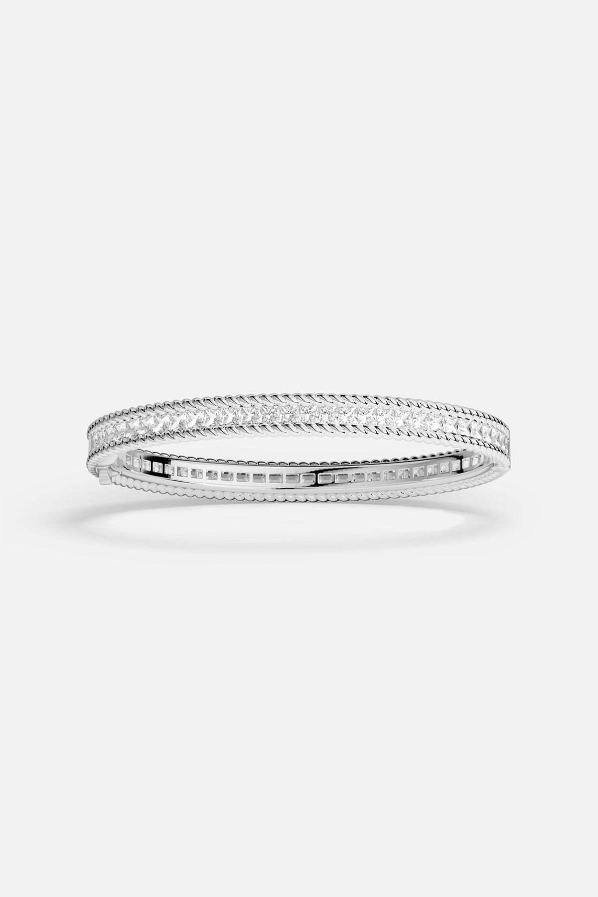 APM Monaco bangle, a luminous line of brilliance framed in rhodium finish.