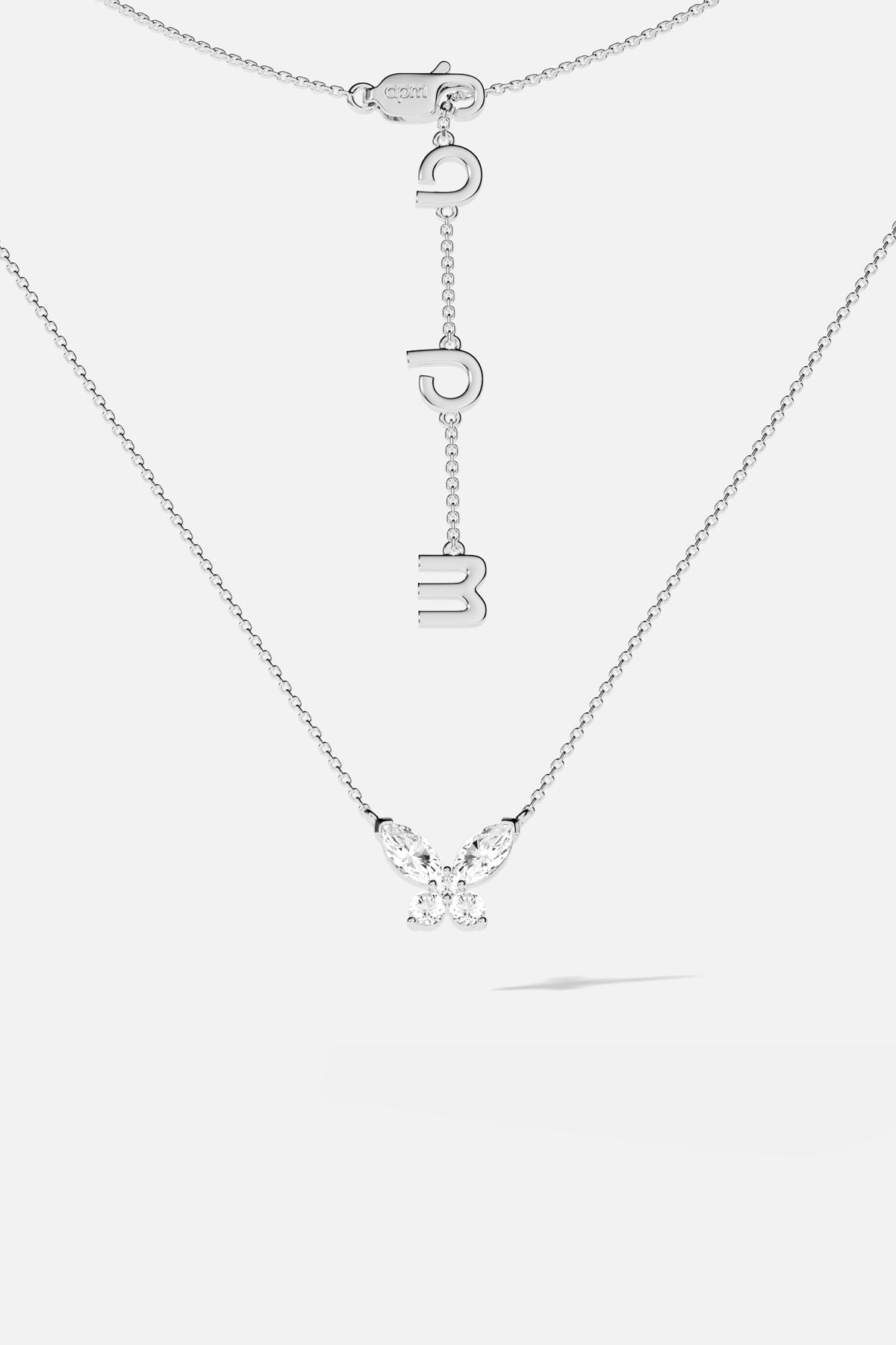 APM Butterfly Necklace, a delicate flutter in rhodium finish, effortlessly luminous.