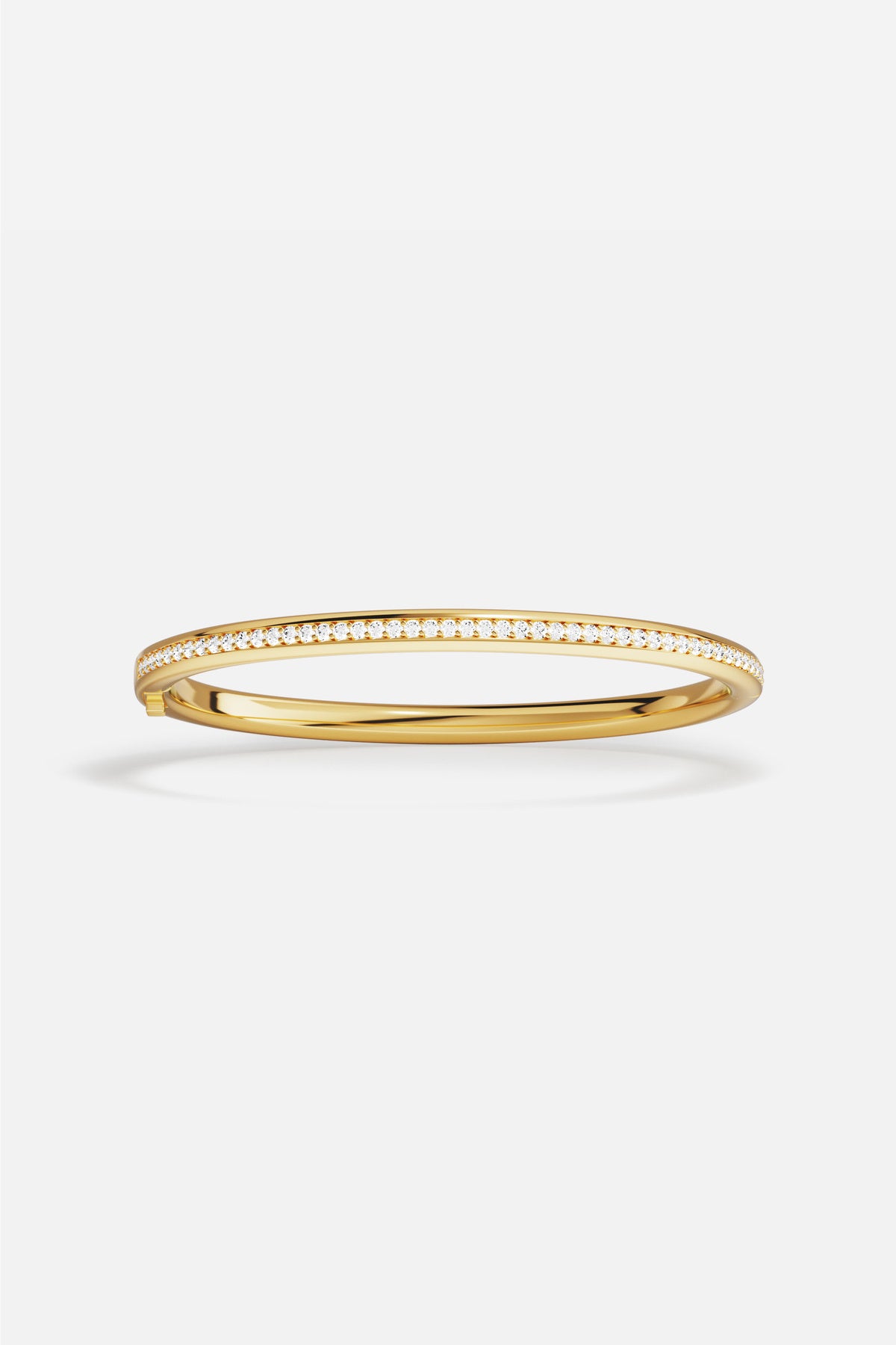 APM Bangle in golden hues, a sleek line of quiet radiance.