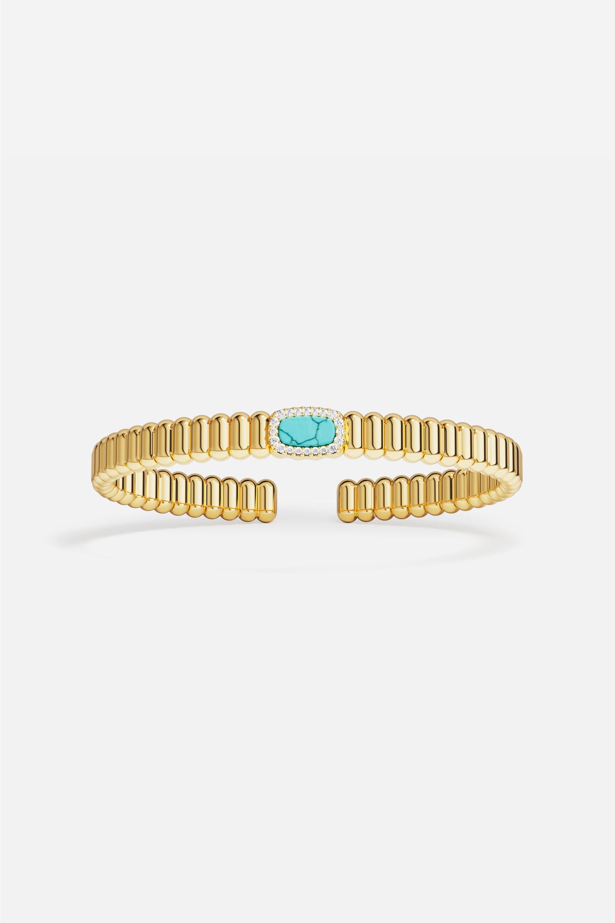 APM ribbed cuff bracelet in golden hues, crowned with a turquoise glow.