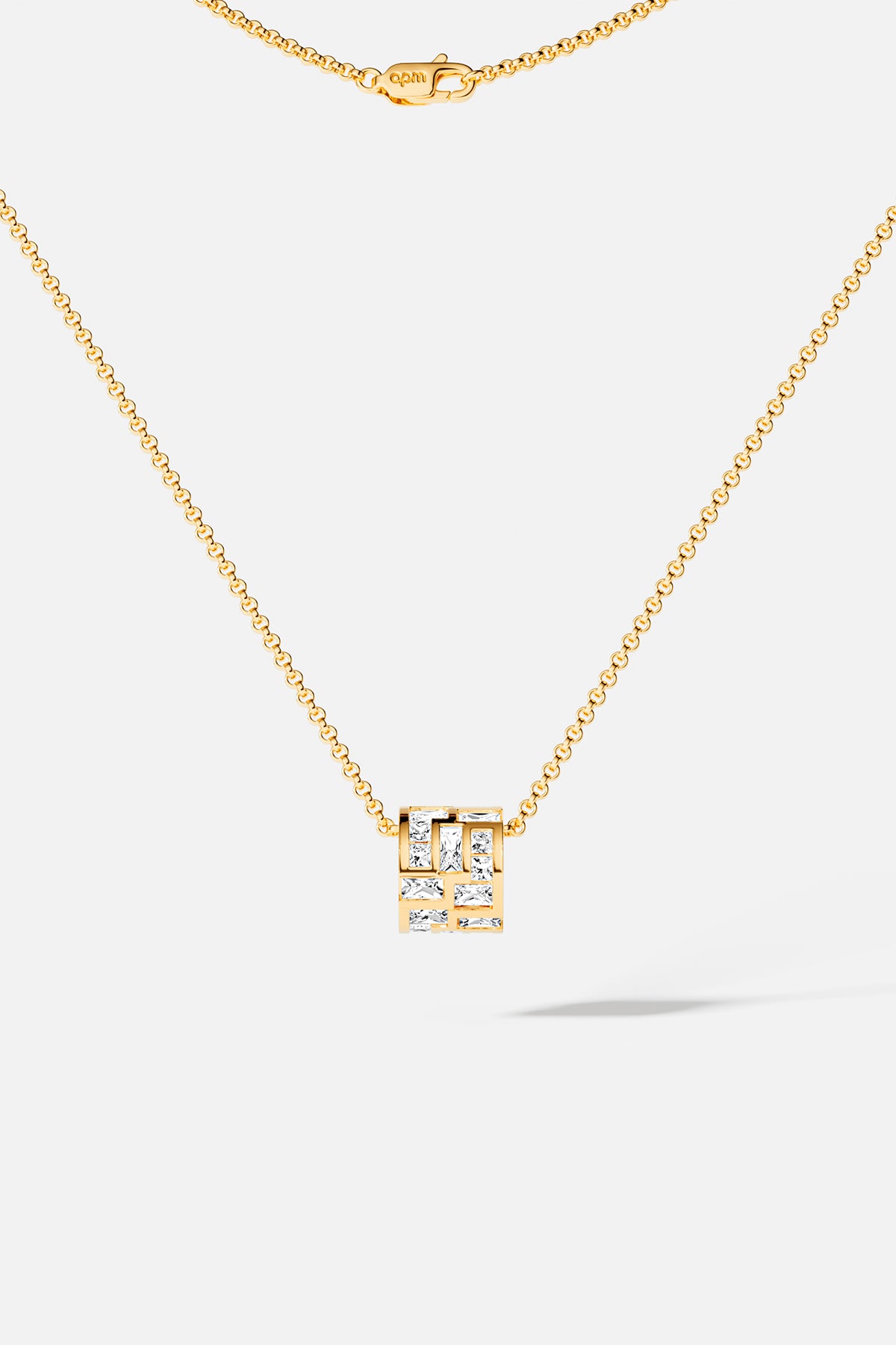 APM Monaco necklace, a golden cube of light, quietly modern and effortlessly chic.