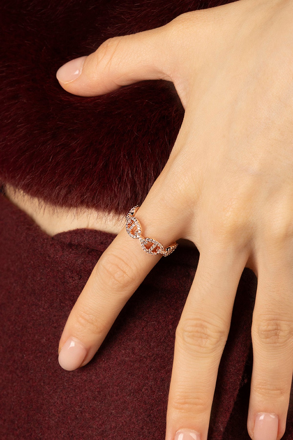 Woman wearing APM Morse Ring, a delicate rose-hued whisper of modern elegance.