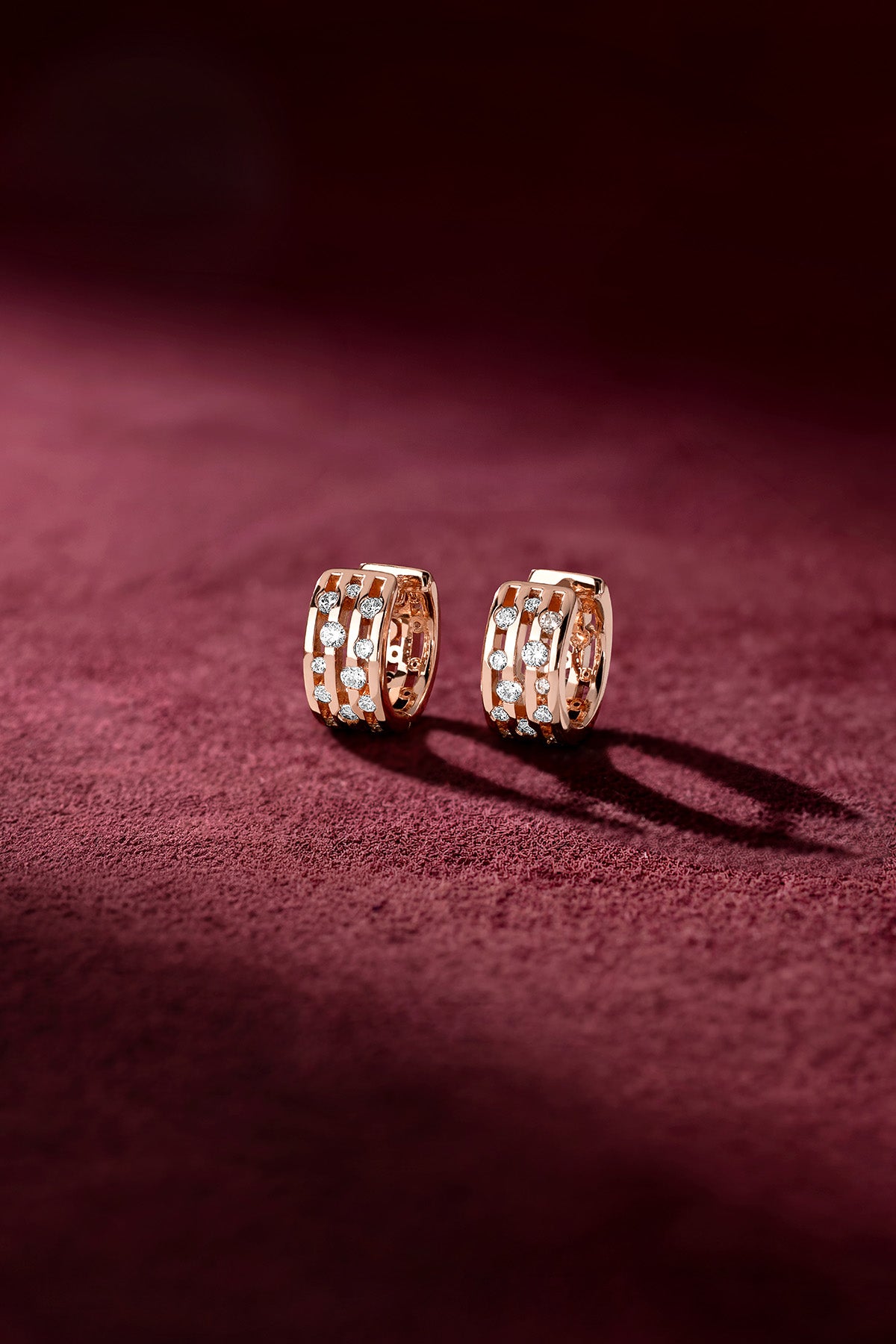 APM Hoop Earrings, a rose-hued glow with sparkling accents on velvet luxury.