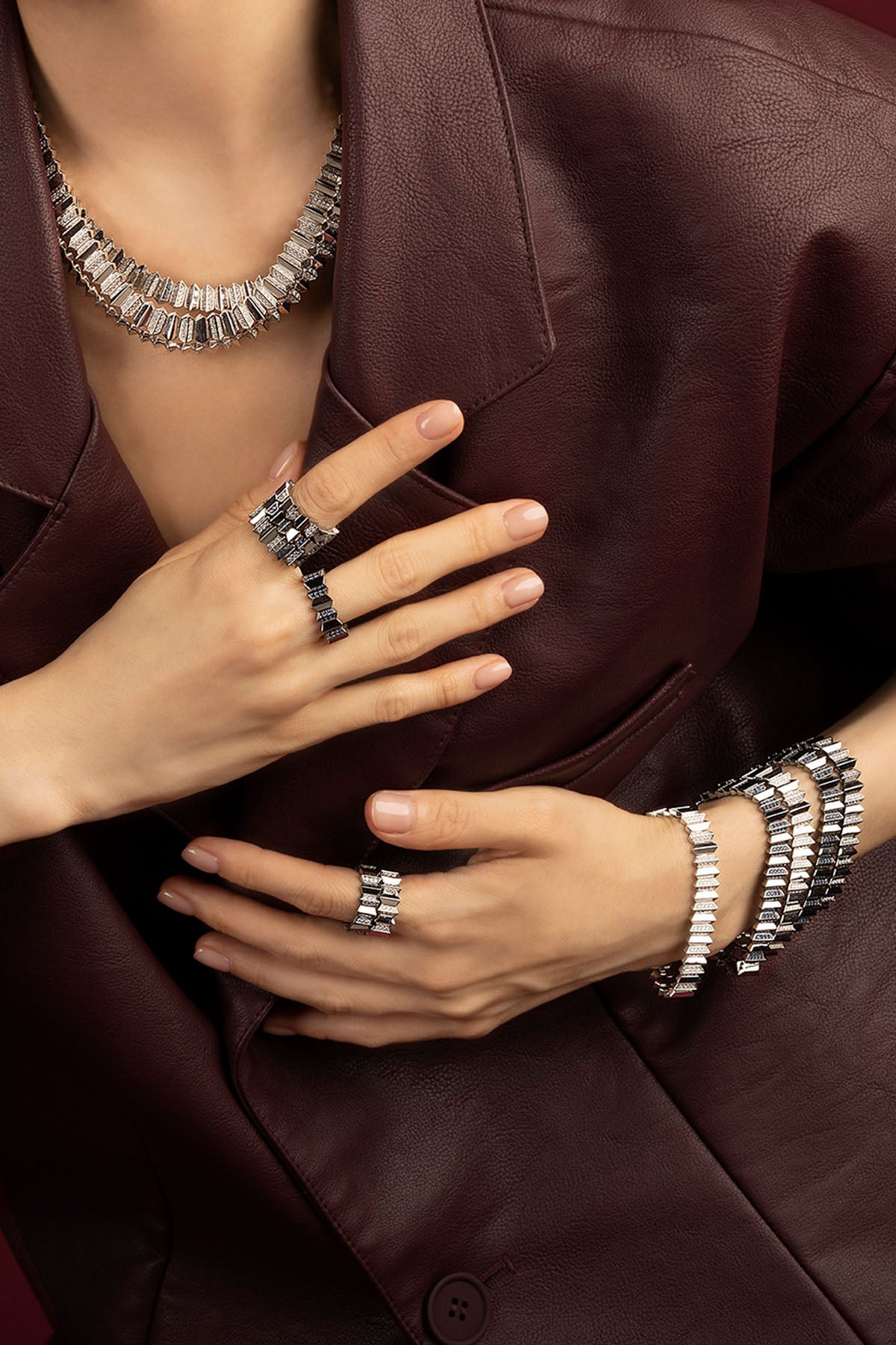 Woman wearing APM Morse jewelry set, bold rhodium finish meets quiet confidence.