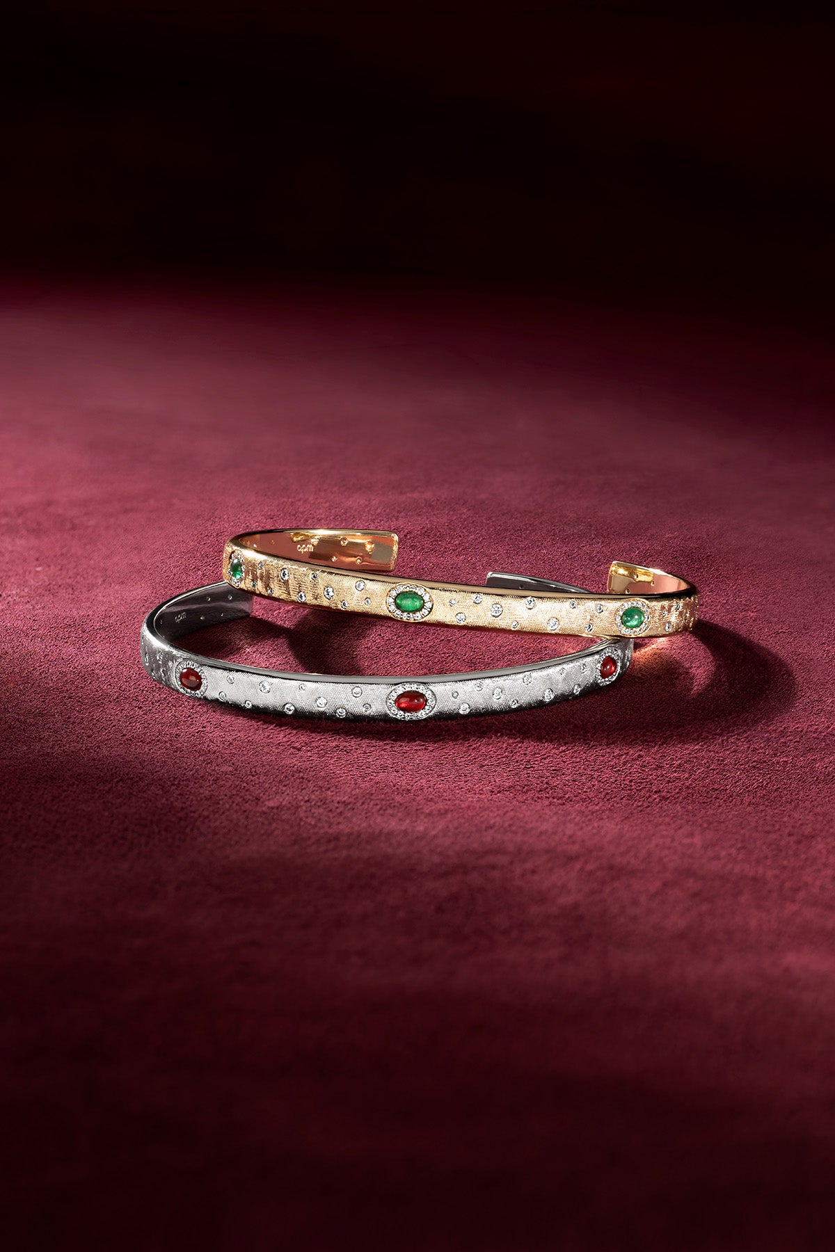 APM Monaco cuff bracelets in gold and rhodium finish, jewel-lit with quiet allure.