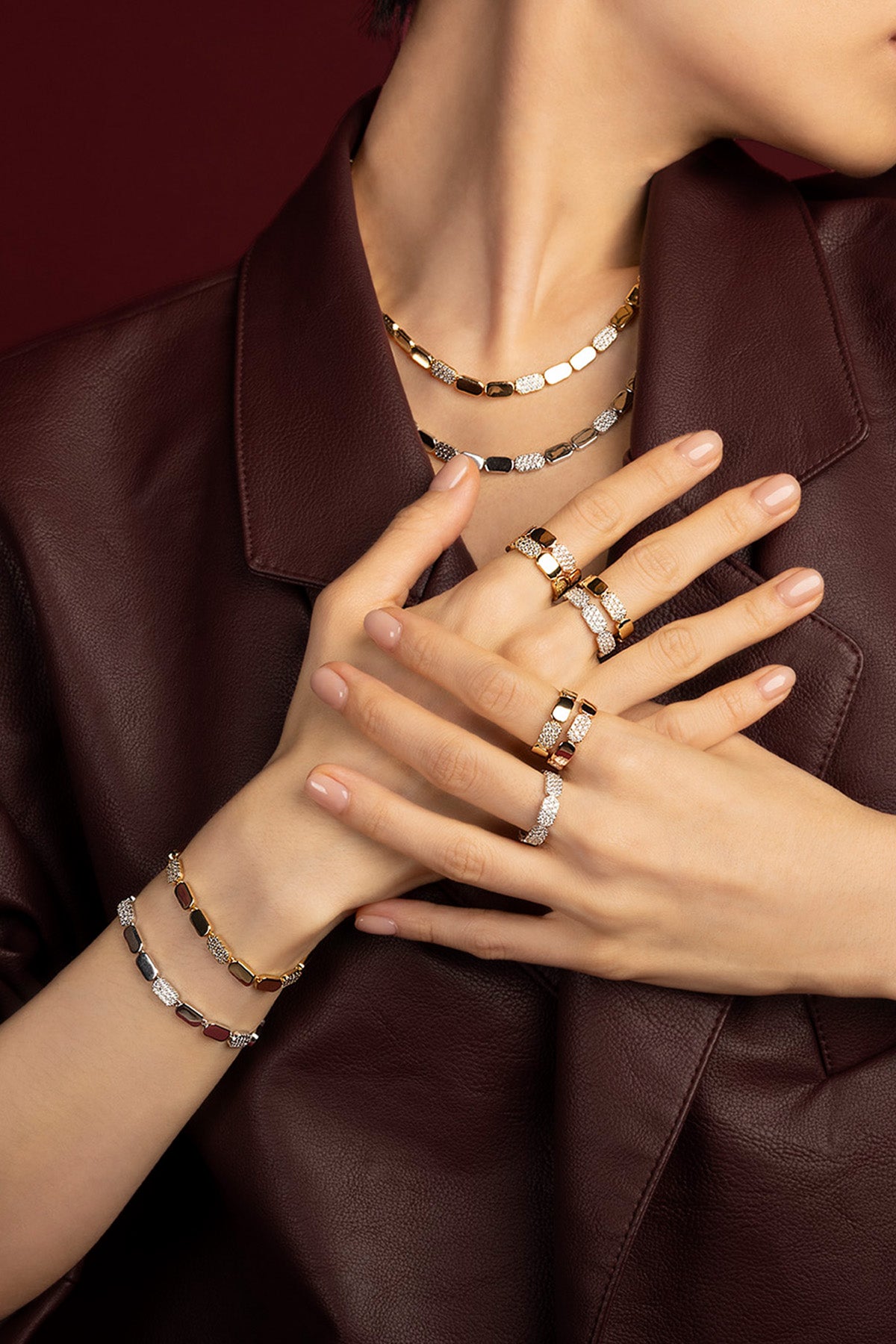 Woman wearing APM Monaco Morse jewelry set, bold elegance in golden and pavé rhythm.