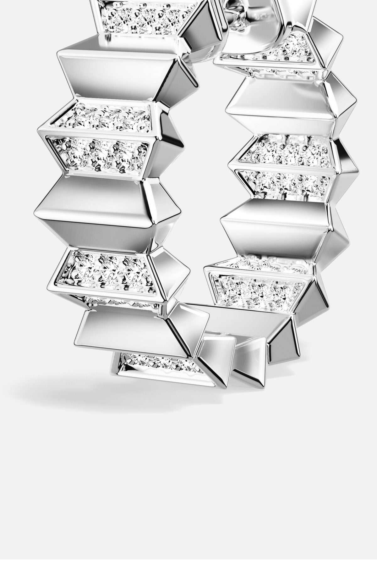 APM Hoop Earrings, sculpted geometry and rhodium finish shimmer with modern edge.
