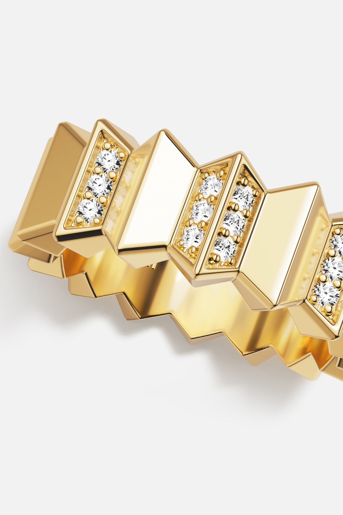 APM Ring in golden color, sculpted edges and shimmering stones for bold elegance.