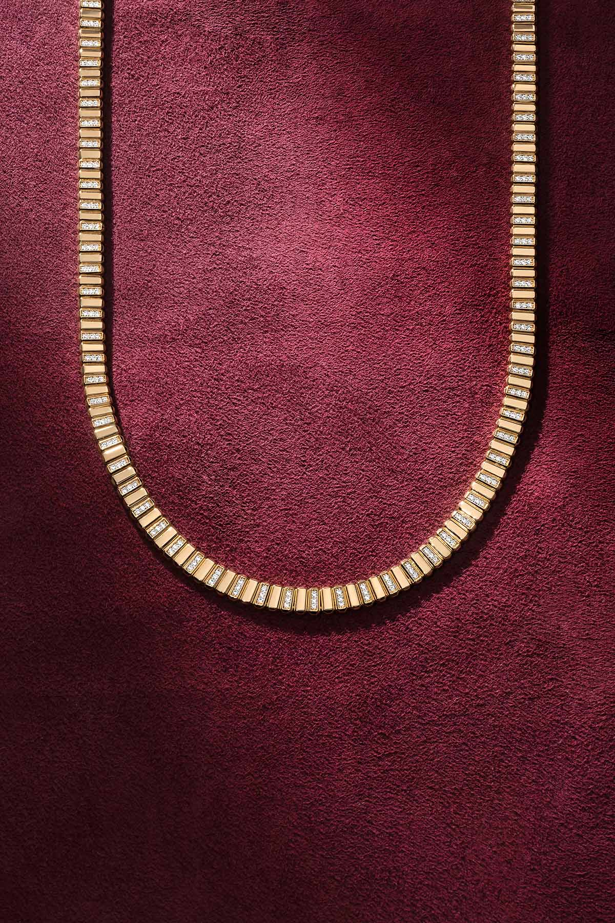 APM Monaco necklace in golden hue, a radiant line of quiet sophistication.