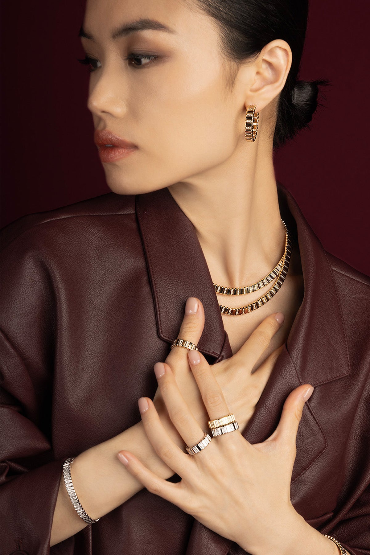 Woman wearing APM Monaco jewelry set, radiant golden allure meets modern sophistication.