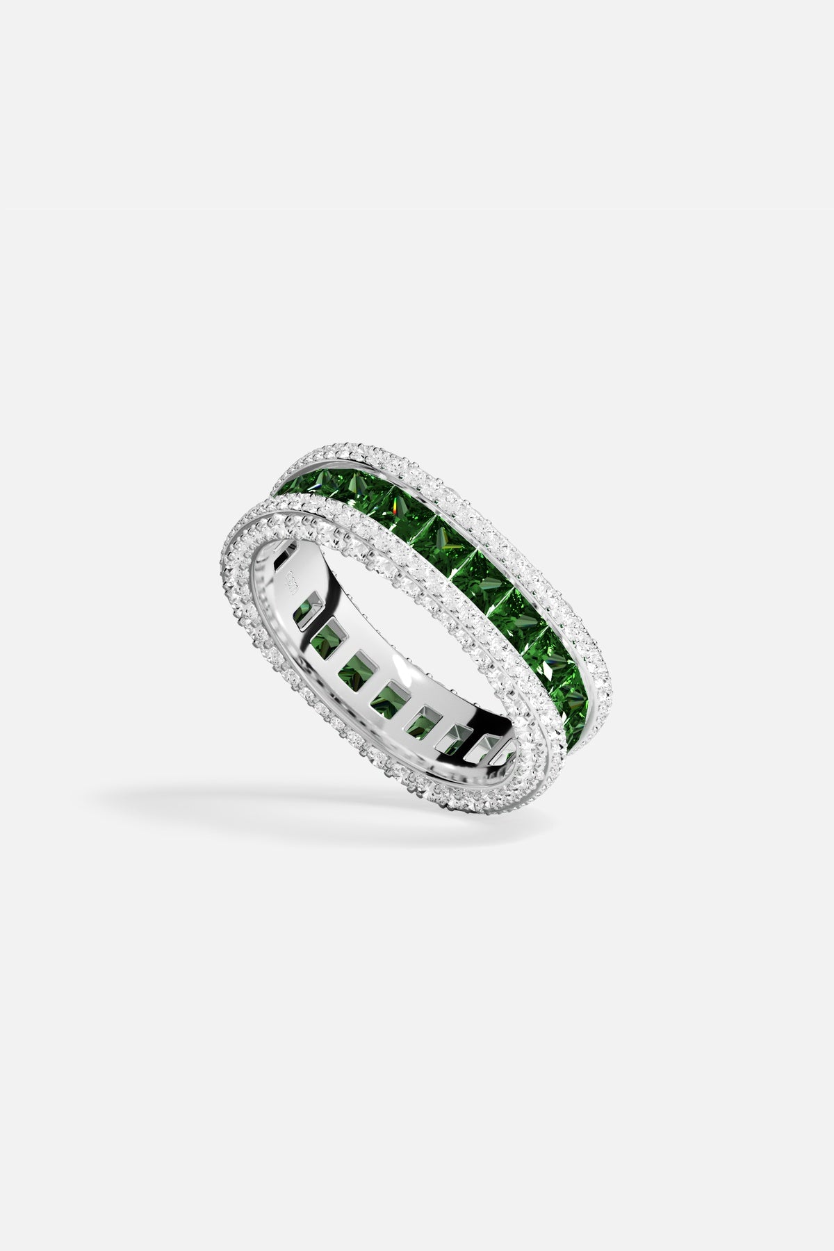 APM Ring in rhodium finish, a vivid green glow framed in sparkling brilliance.