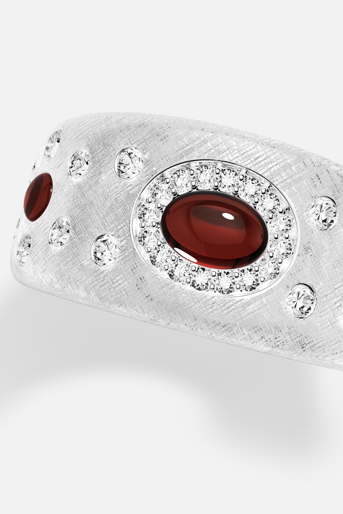 APM Ring in rhodium finish, deep red cabochon aglow with quiet, textured elegance.