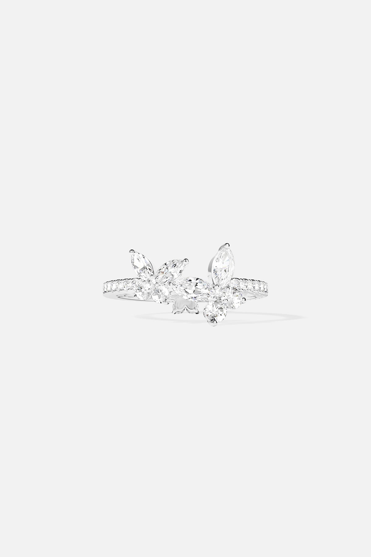 Rings APM Monaco. White gold ring with white pavé diamonds, floral-inspired silhouette.
