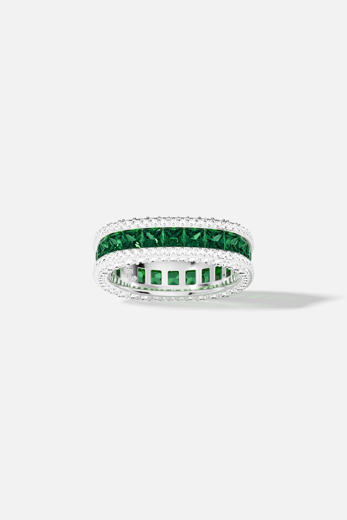 Silver ring with green and white stones on a white background