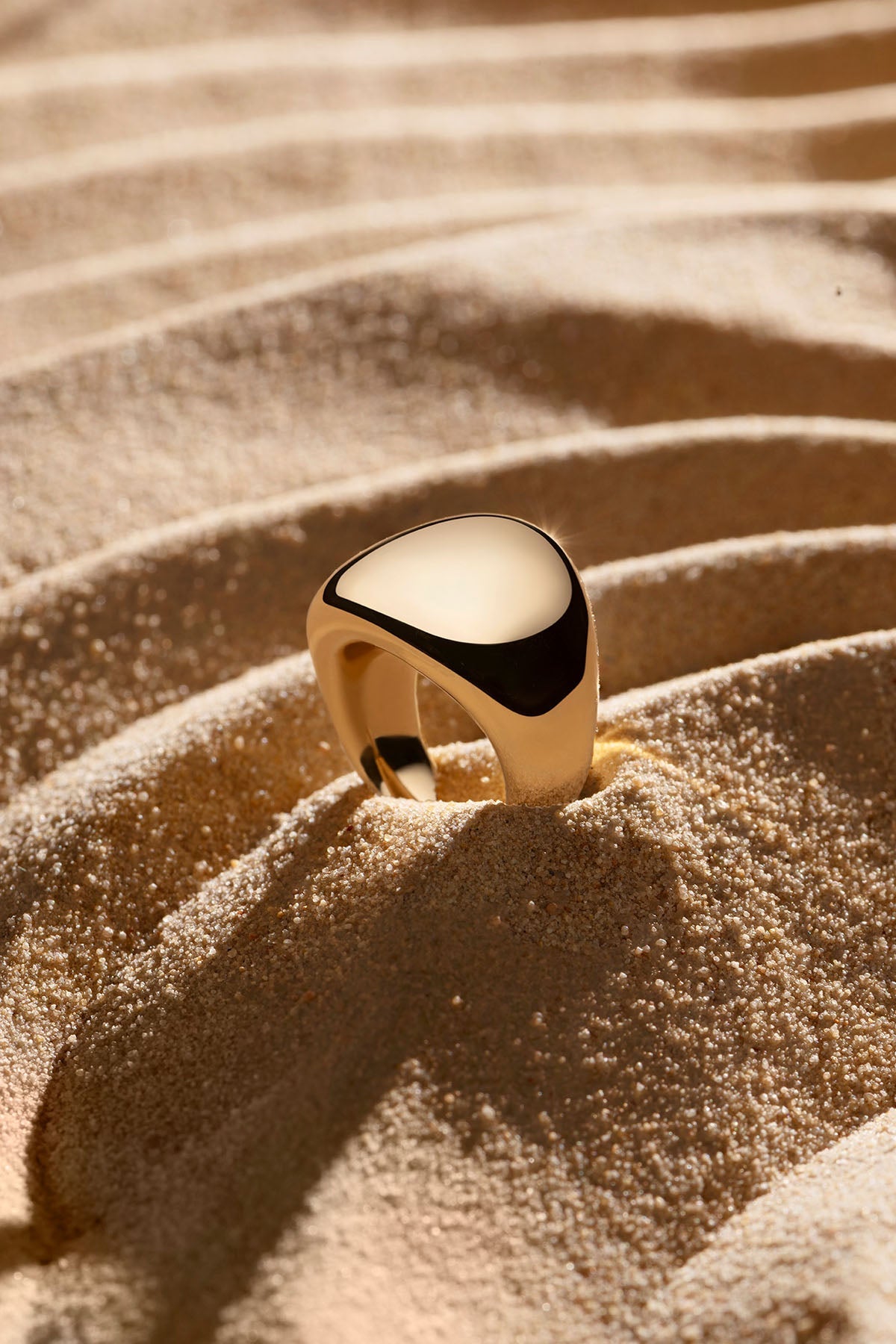 APM Monaco Dome Ring in yellow gold on soft beach