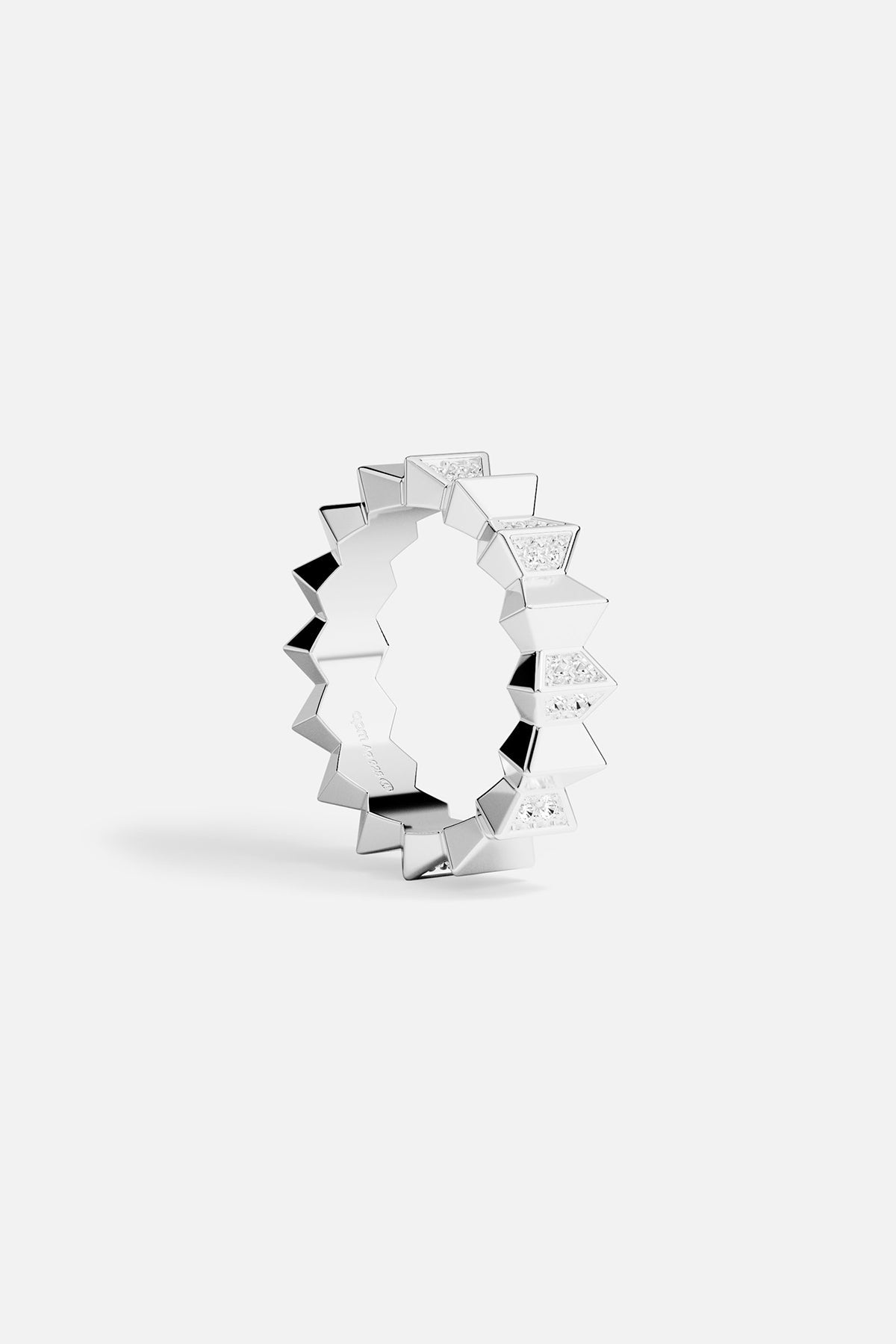 Silver ring with geometric design on a white background