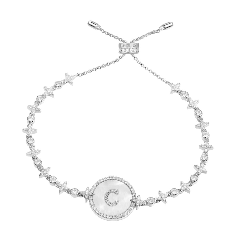 Bracelets APM Monaco: silver-tone bracelet with a circular center featuring a mother-of-pearl inlay and a rhinestone-studded 'C' and a chain with star-shaped rhinestone accents.