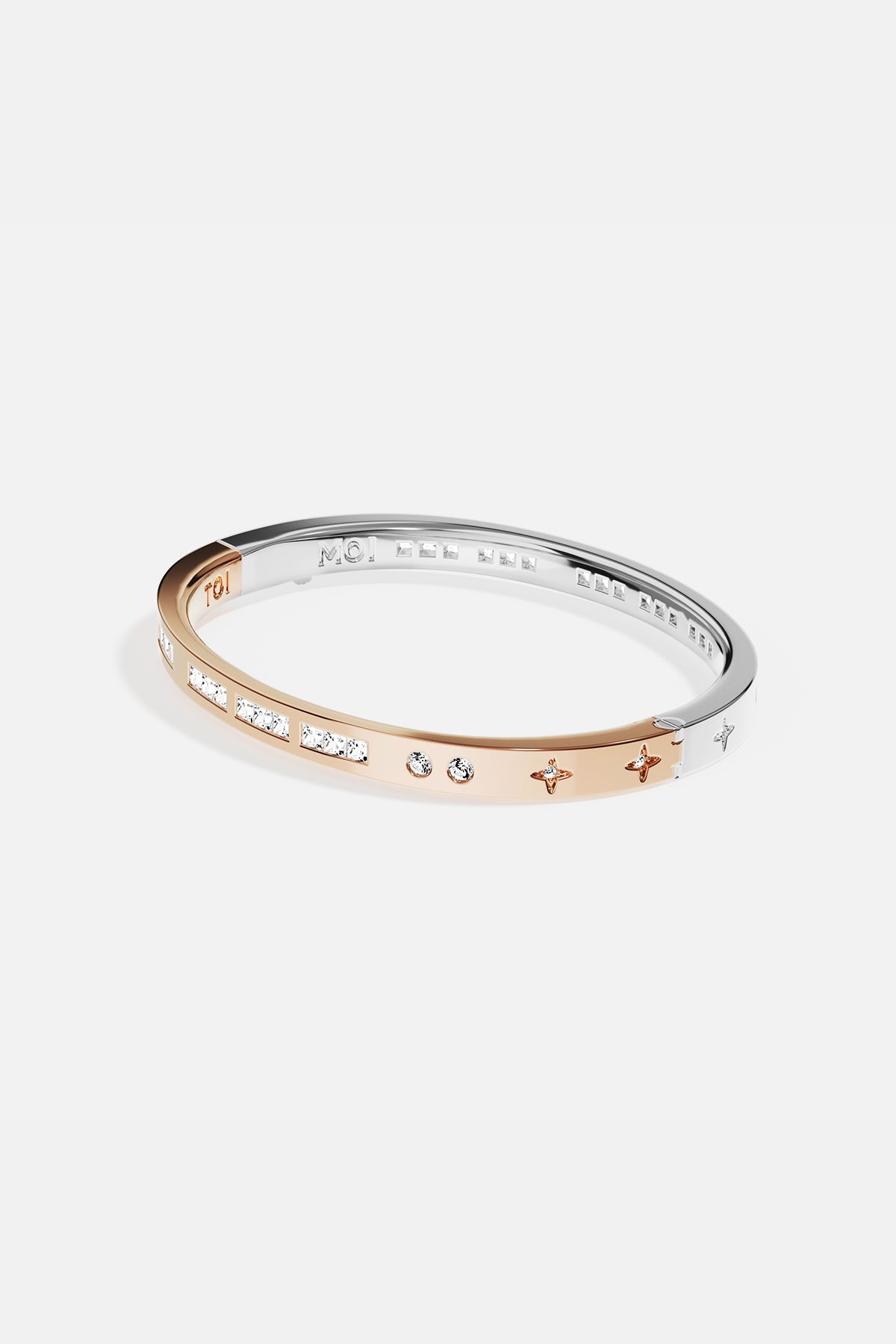 Bracelets APM Monaco two-tone gold and silver bangle with inlaid white stones.