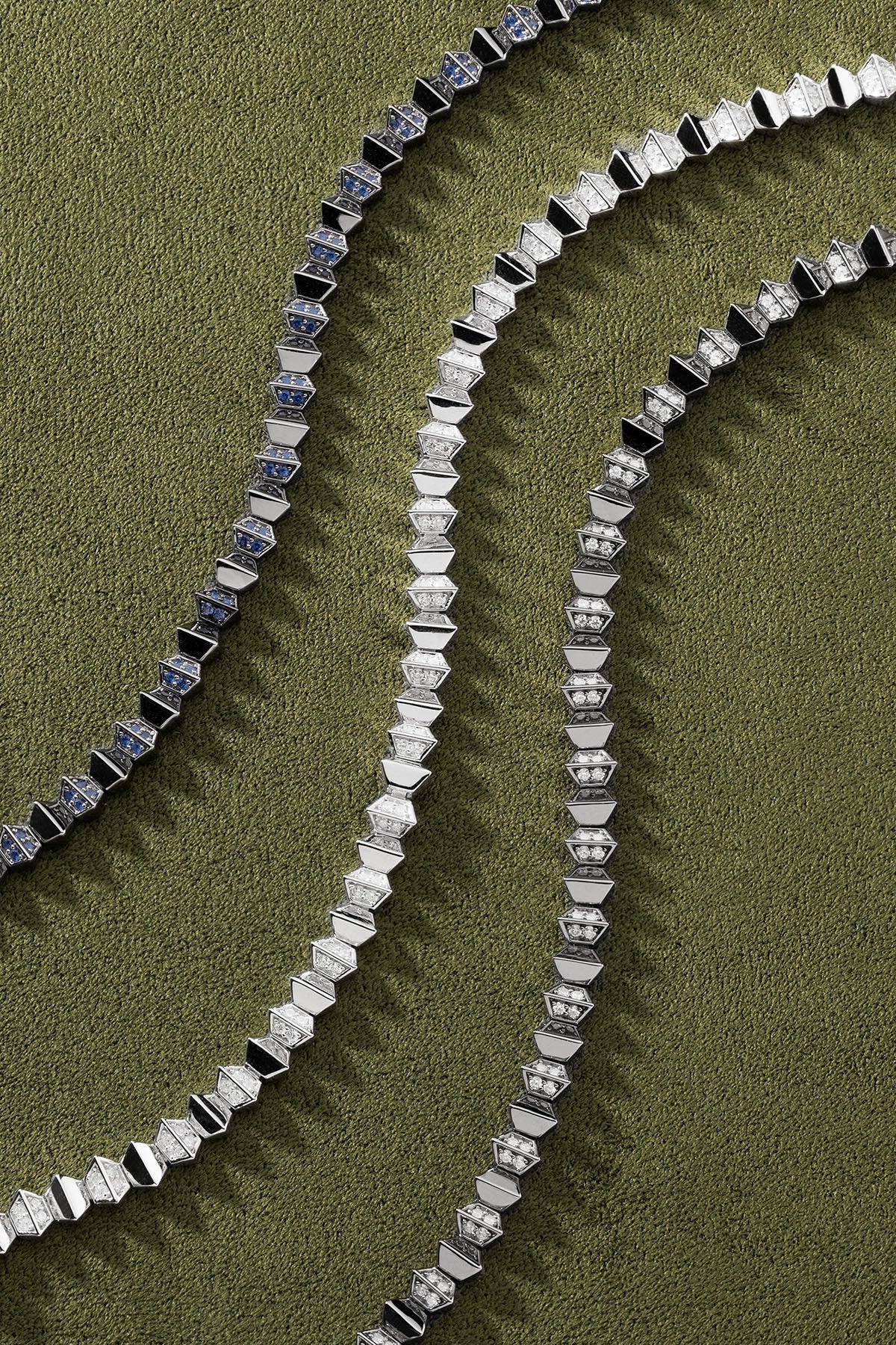 APM Monaco Up and Down Bracelet in dark grey on a green background