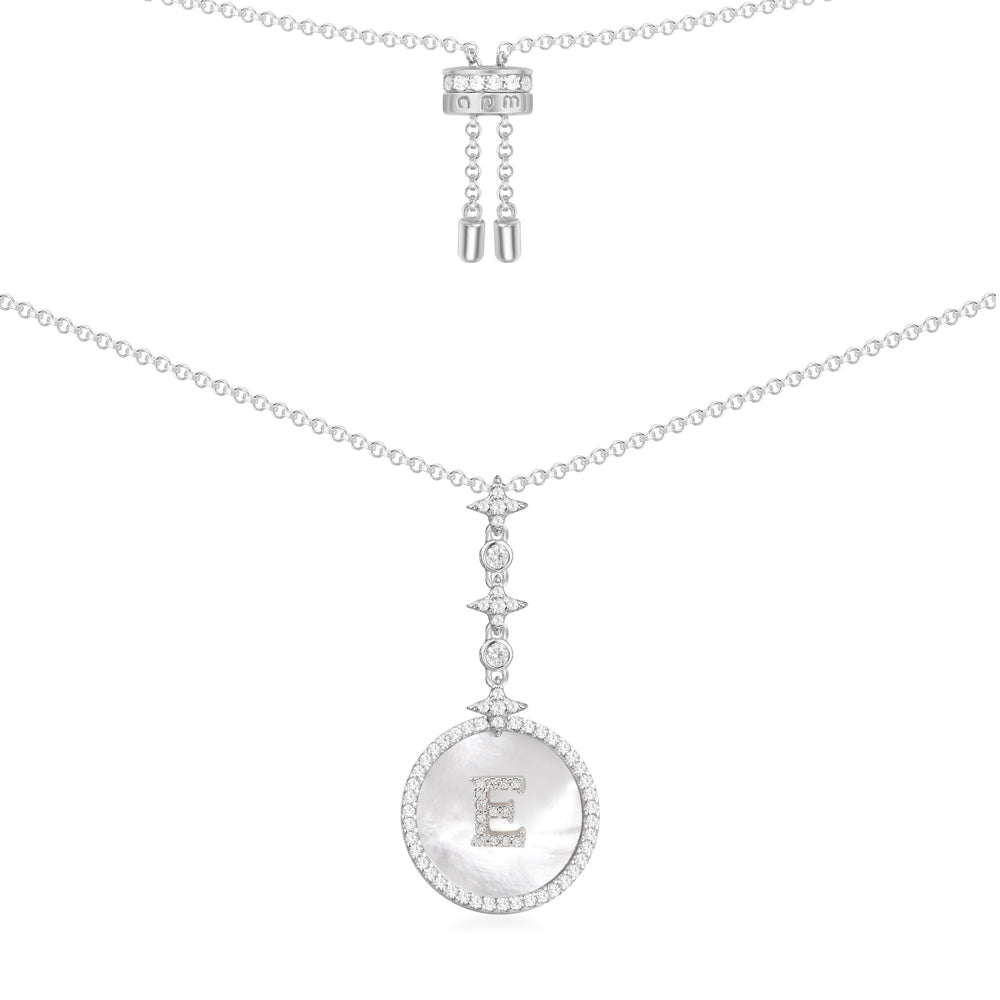 Necklaces APM Monaco. Round pendant of white mother-of-pearl with an E initial at the center on a thin silver chain.