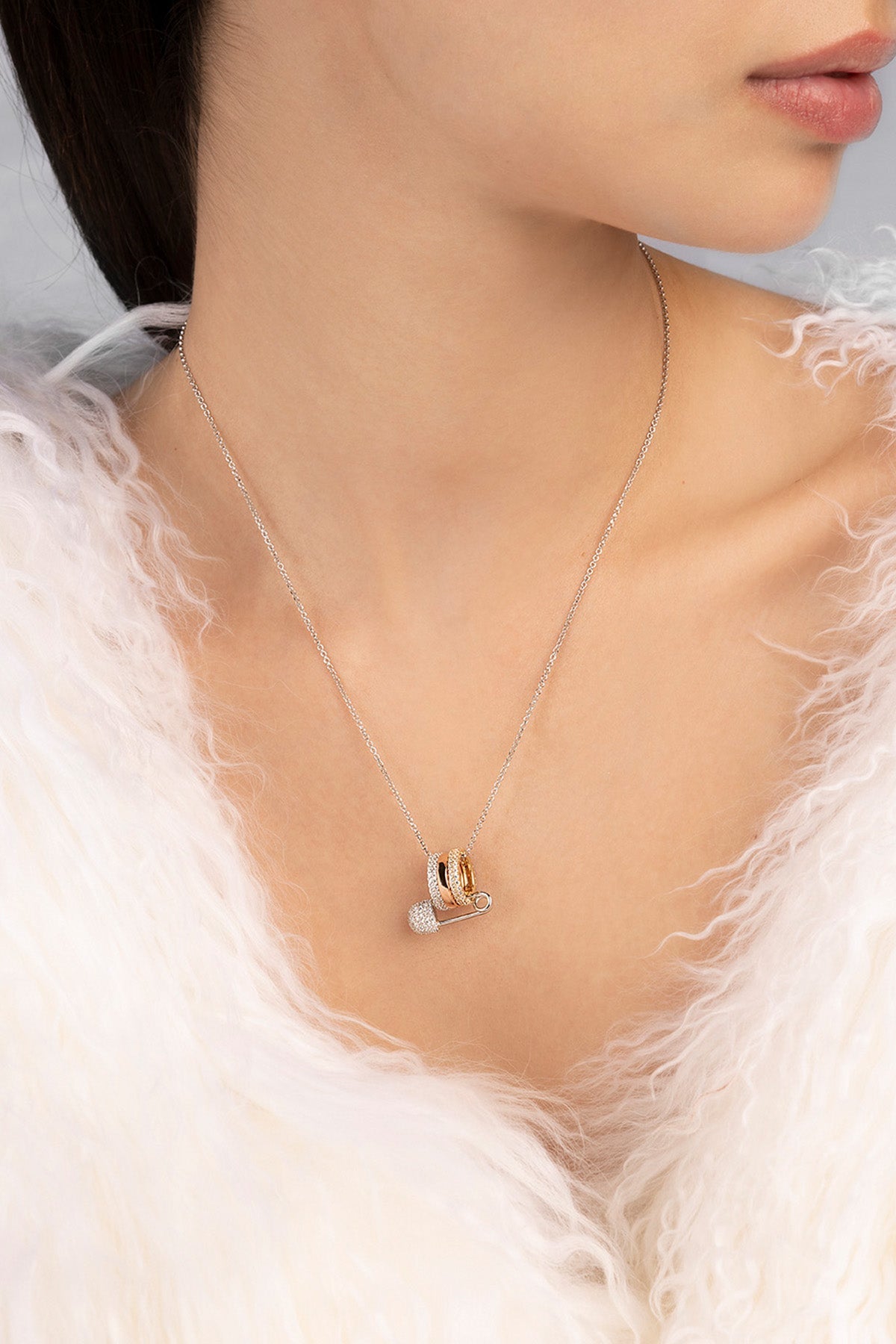 Necklace with a heart-shaped pendant worn by a person