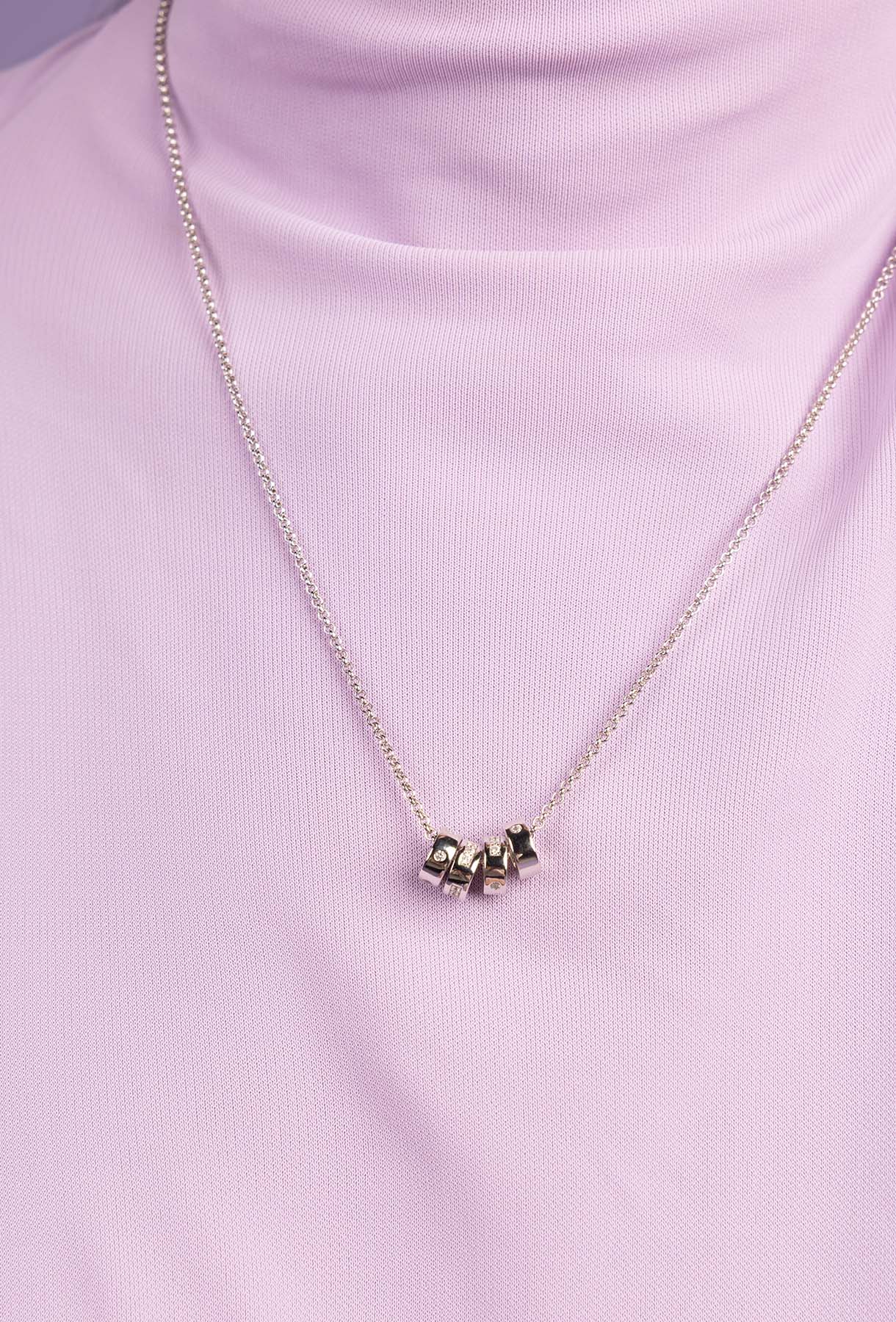 Necklace with star-shaped pendant on a pink background