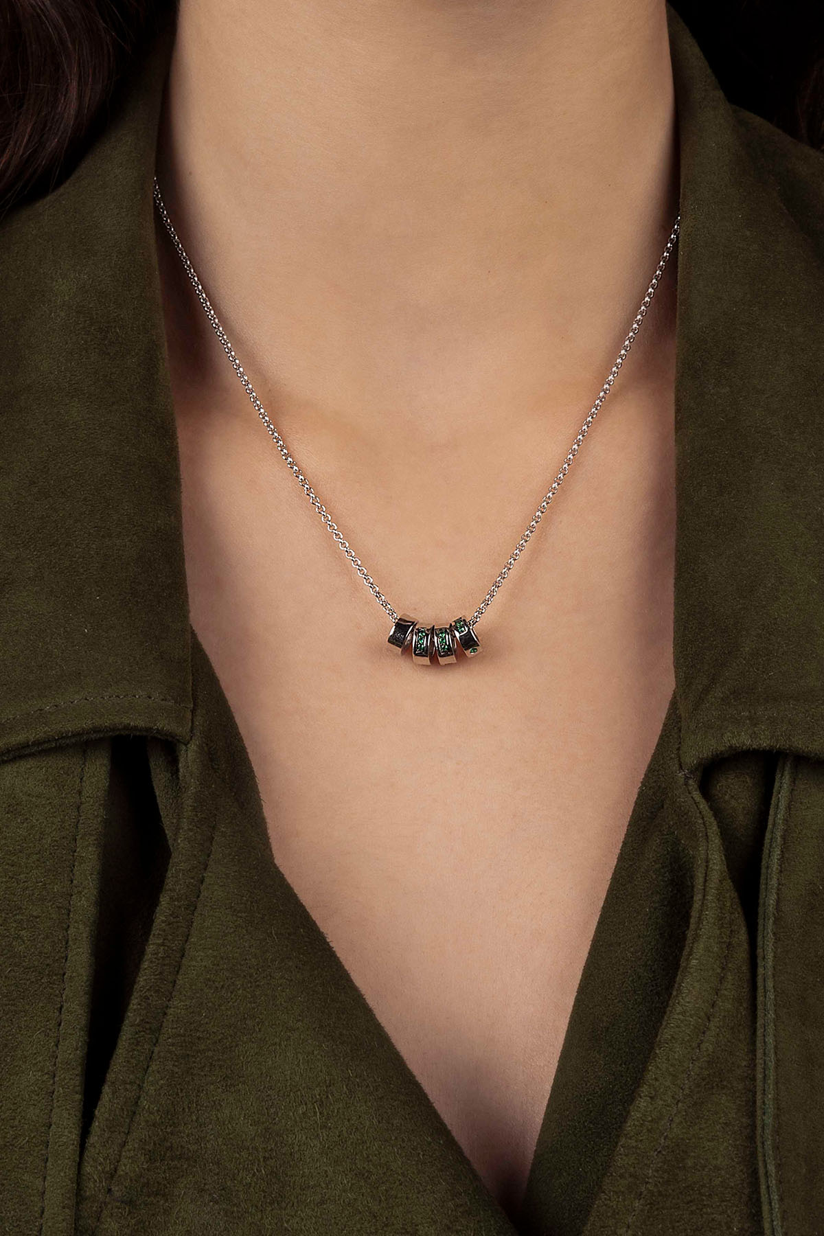 Necklace with a pendant worn by a model against a dark background