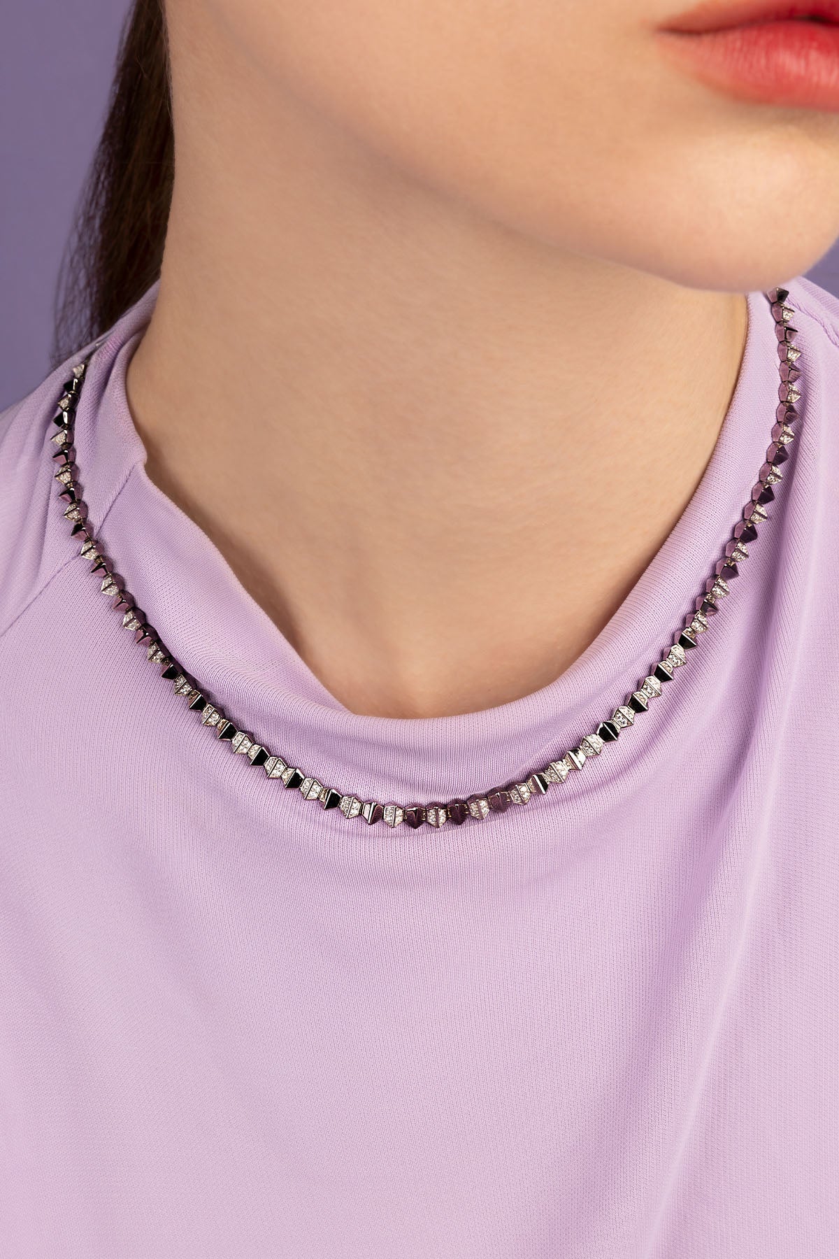 Necklace worn by a model, focusing on the necklace.
