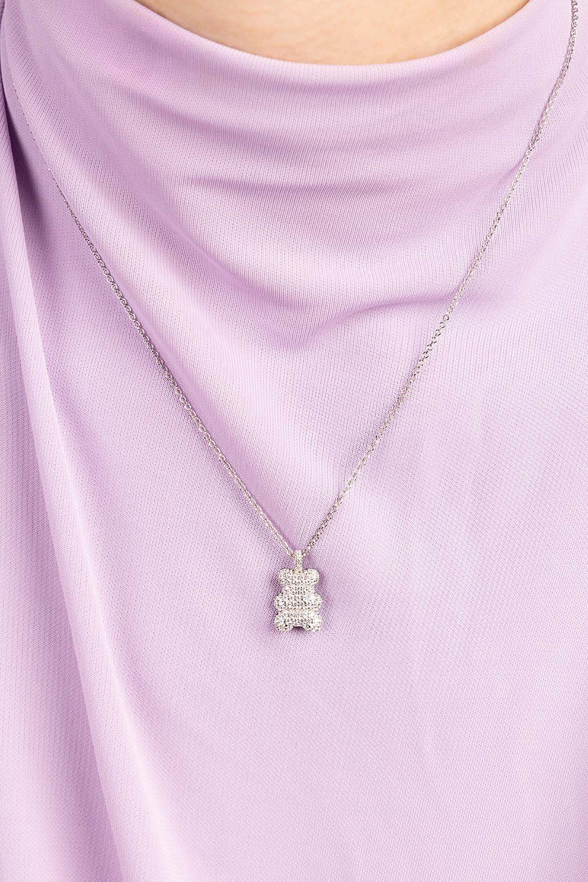 APM Monaco Baby Baba Yummy Bear Adjustable necklace wearing a light purple top against a purple background