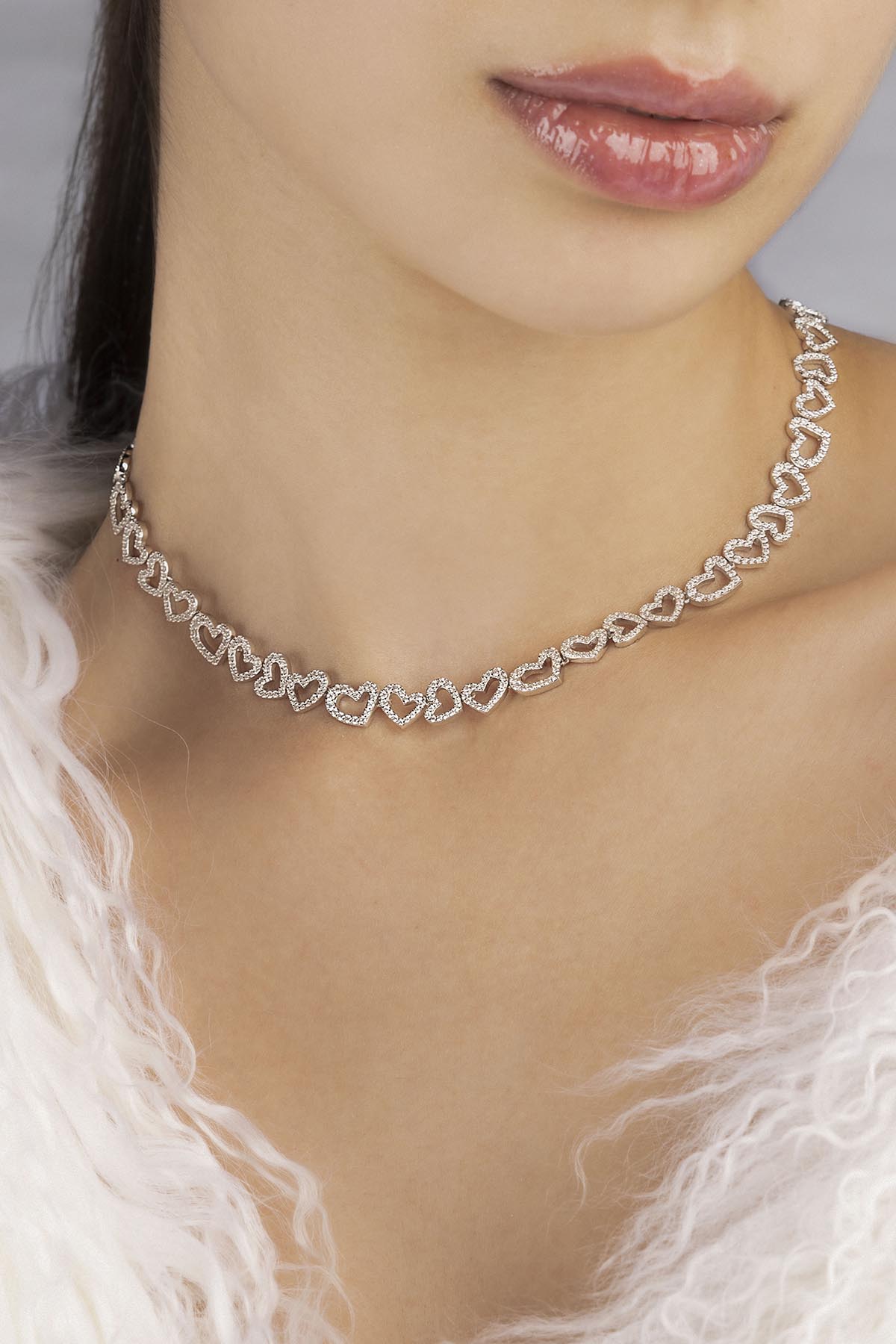 APM MONACO heart-shaped necklace in silver worn on model