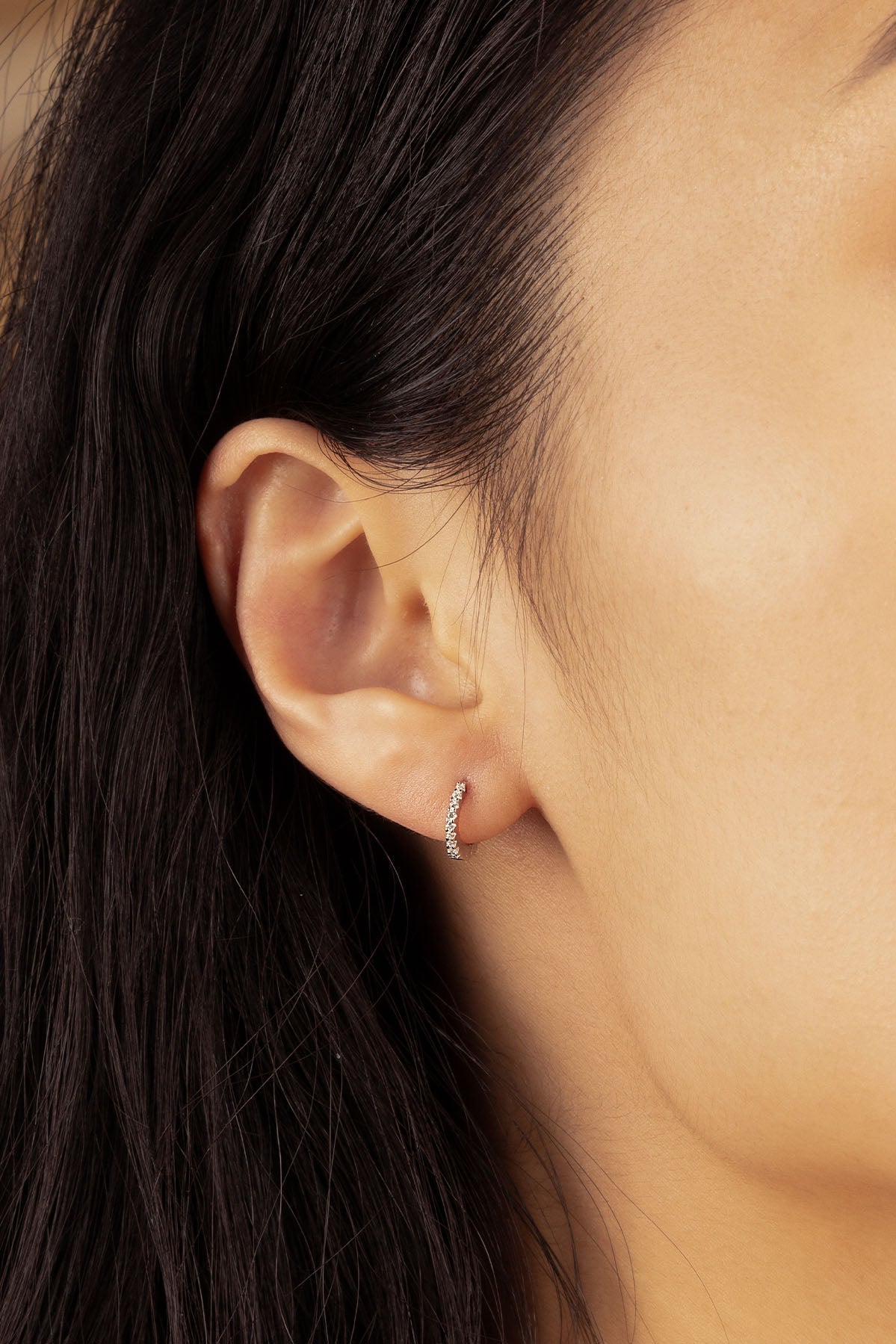 APM Monaco Small 6 mm Paved Hoop Earrings in Silver worn on hand
