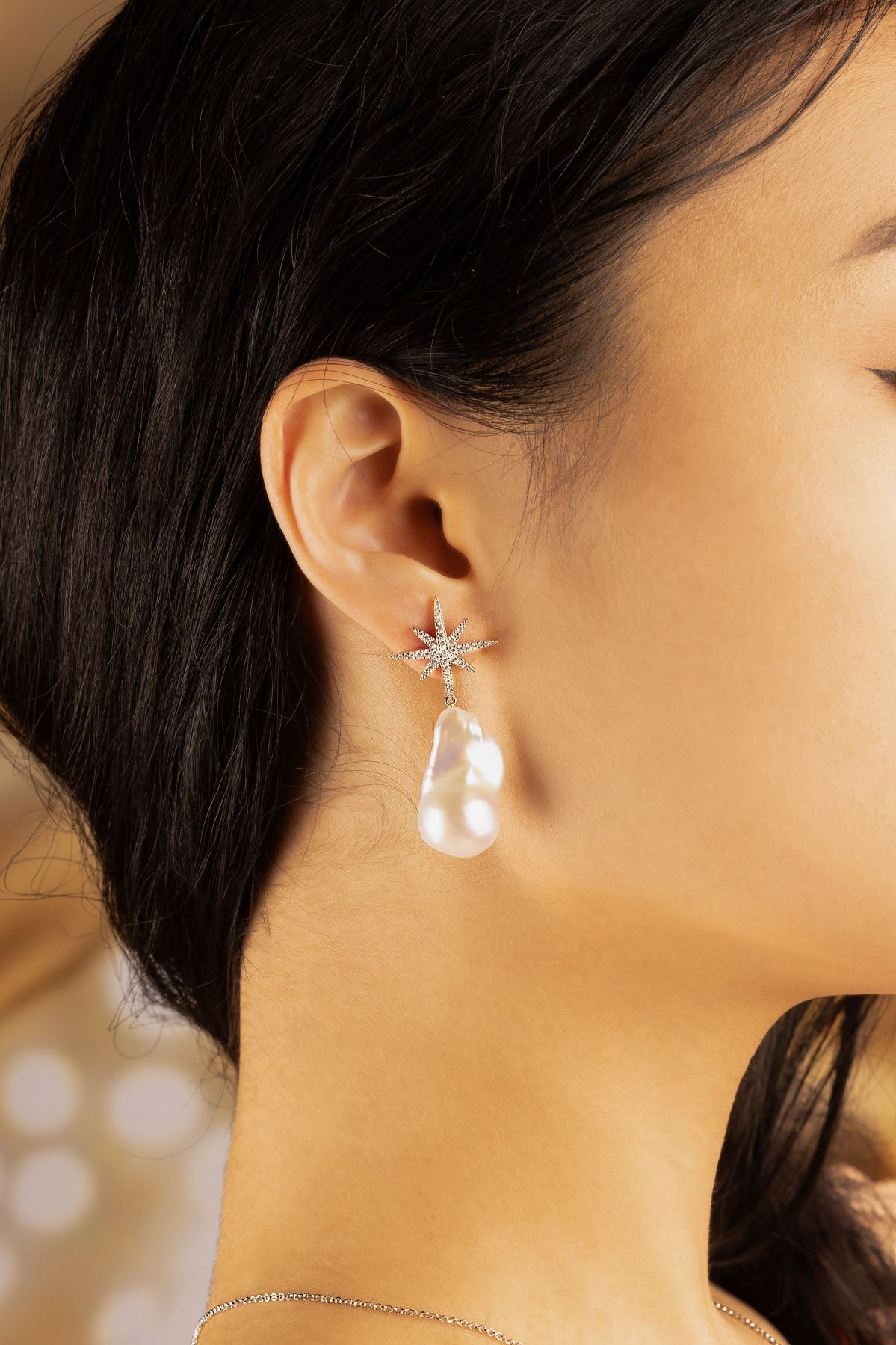 APM Monaco Météorites Studs with Pearls in Silver worn on ear