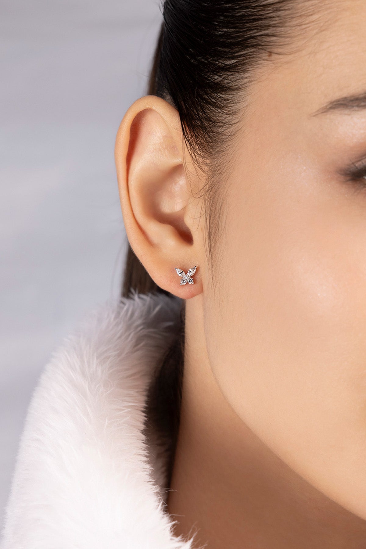 APM MONACO butterfly stud earrings in silver worn on model