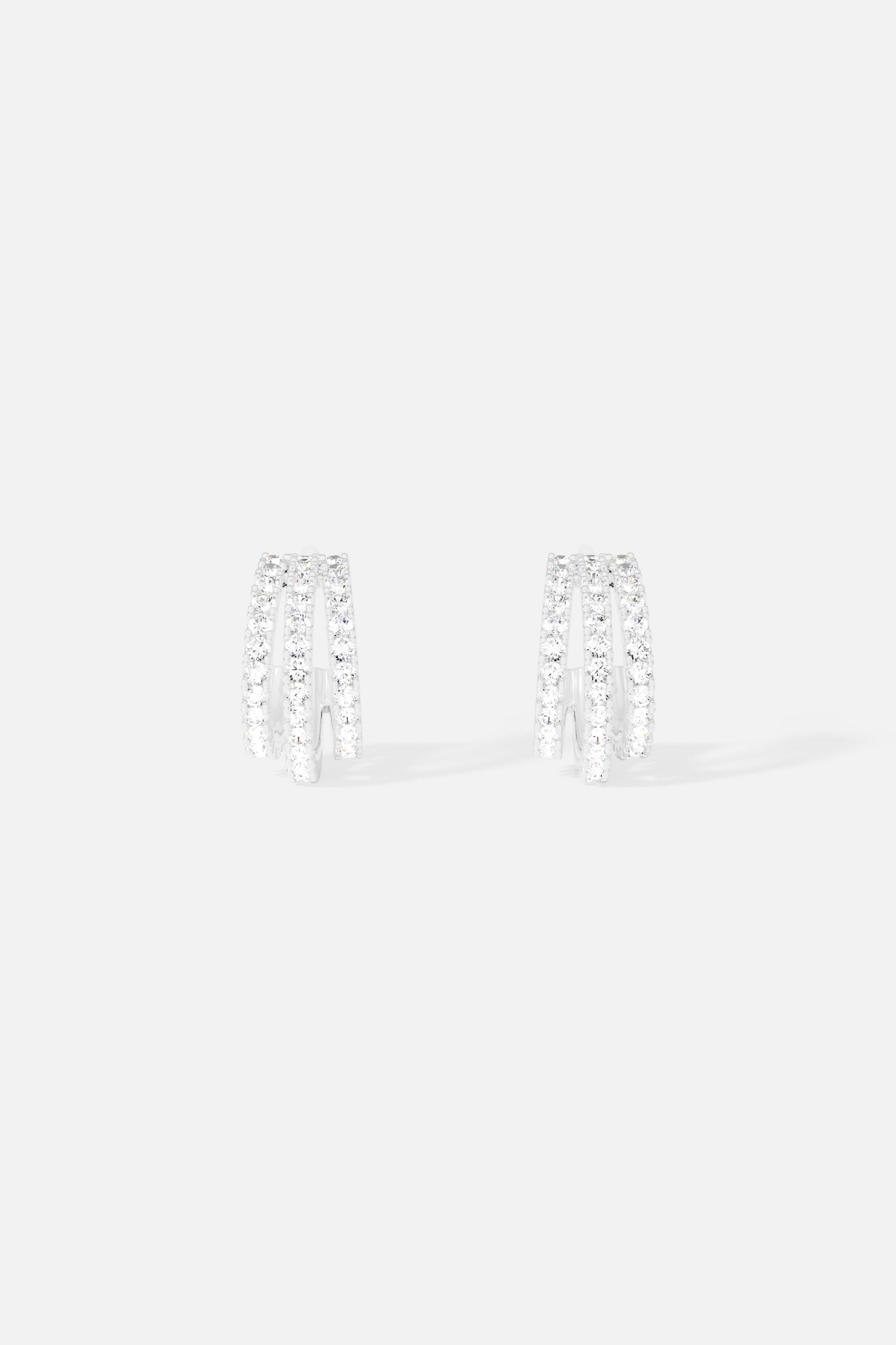 Earrings APM Monaco: white, triple-hoop earrings in a semi-circular shape.