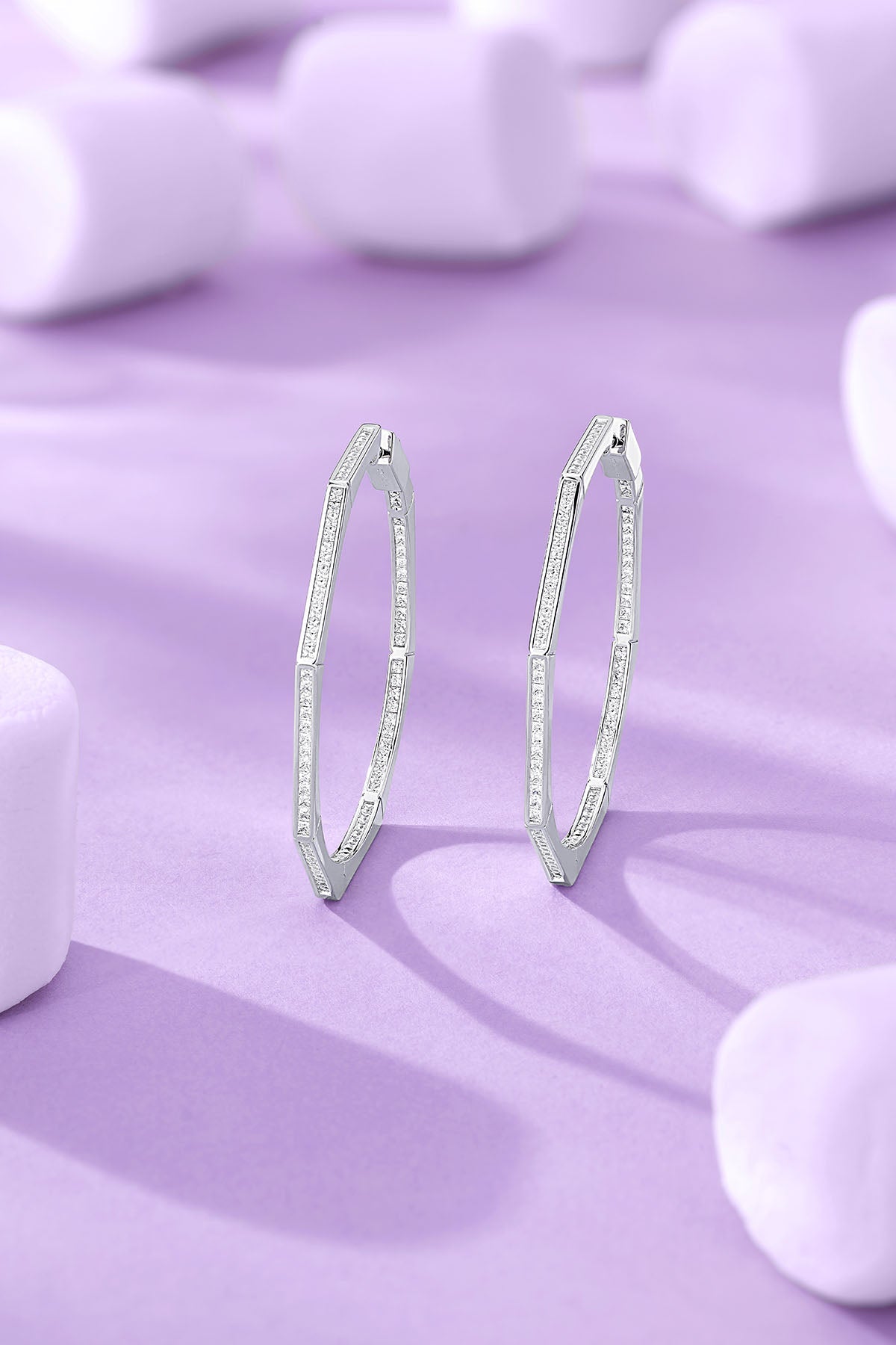 Geometric Pavé Hoop Earrings on a purple background