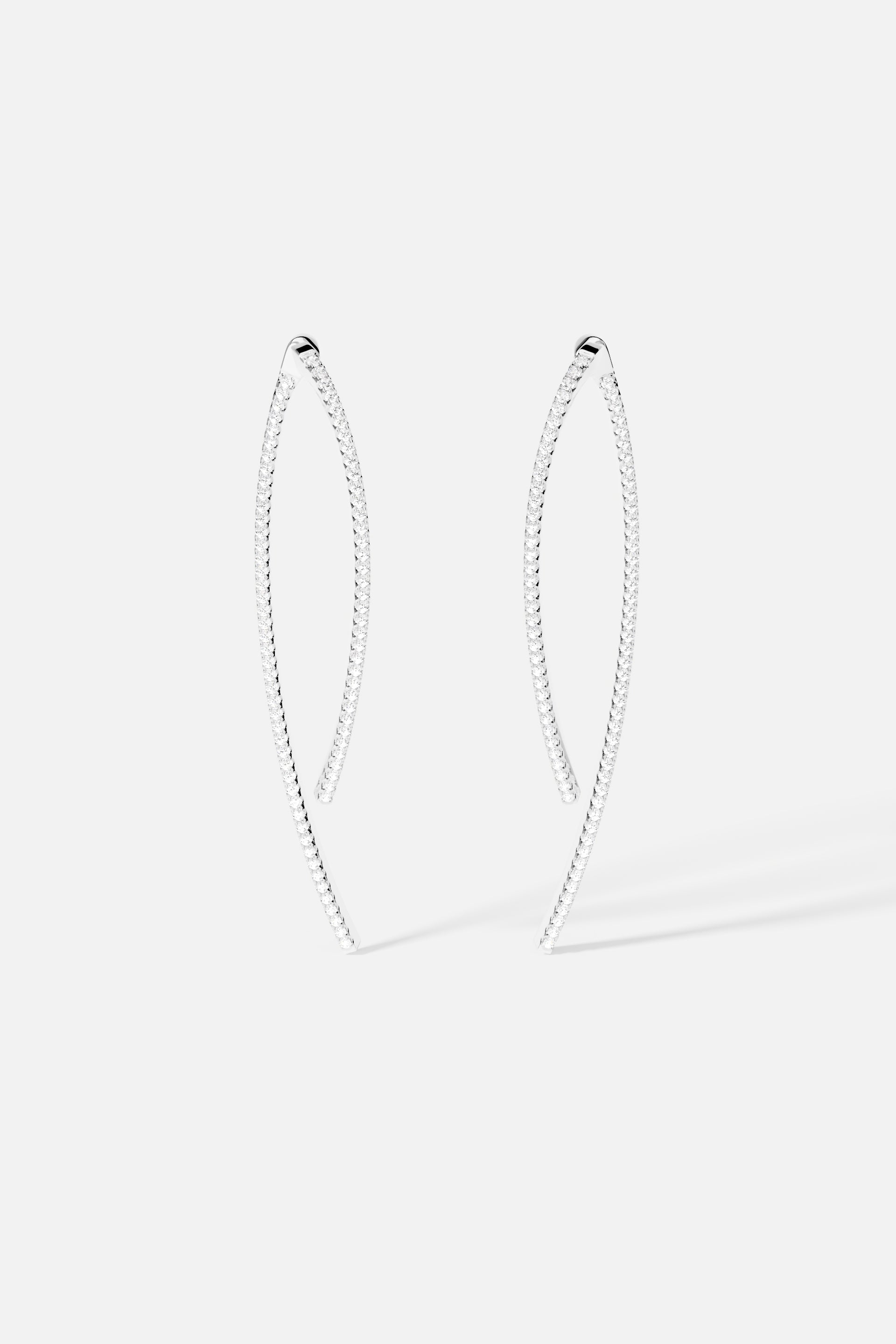 Earrings, APM Monaco: white pavé geometric drop earrings in silver-tone metal, elongated curved silhouette.