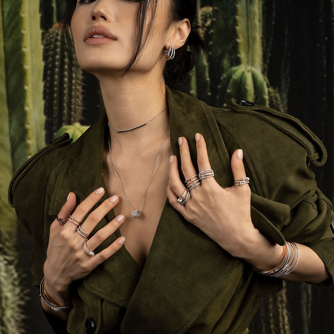 Woman wearing apm monaco pave jewelry with cacti in the background