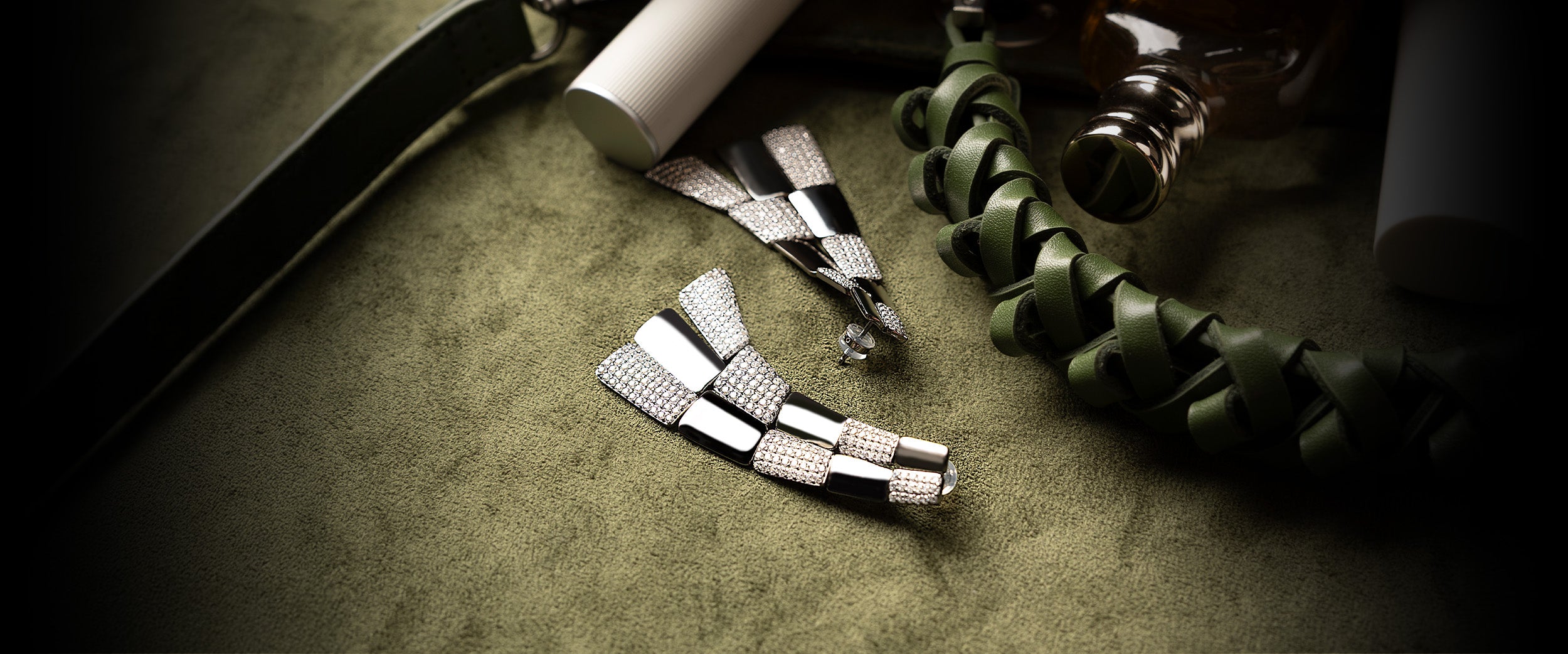 APM MONACO pave statement earrings on khaki soft surface