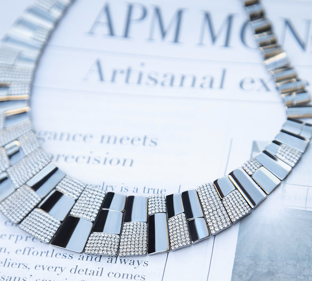 Pave statement silver necklace on a magazine page with 'APM MONACO' branding.