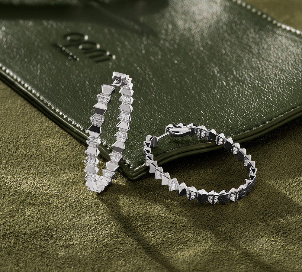 APM MONACO up and down big loop earrings in silver on khaki soft bag surface