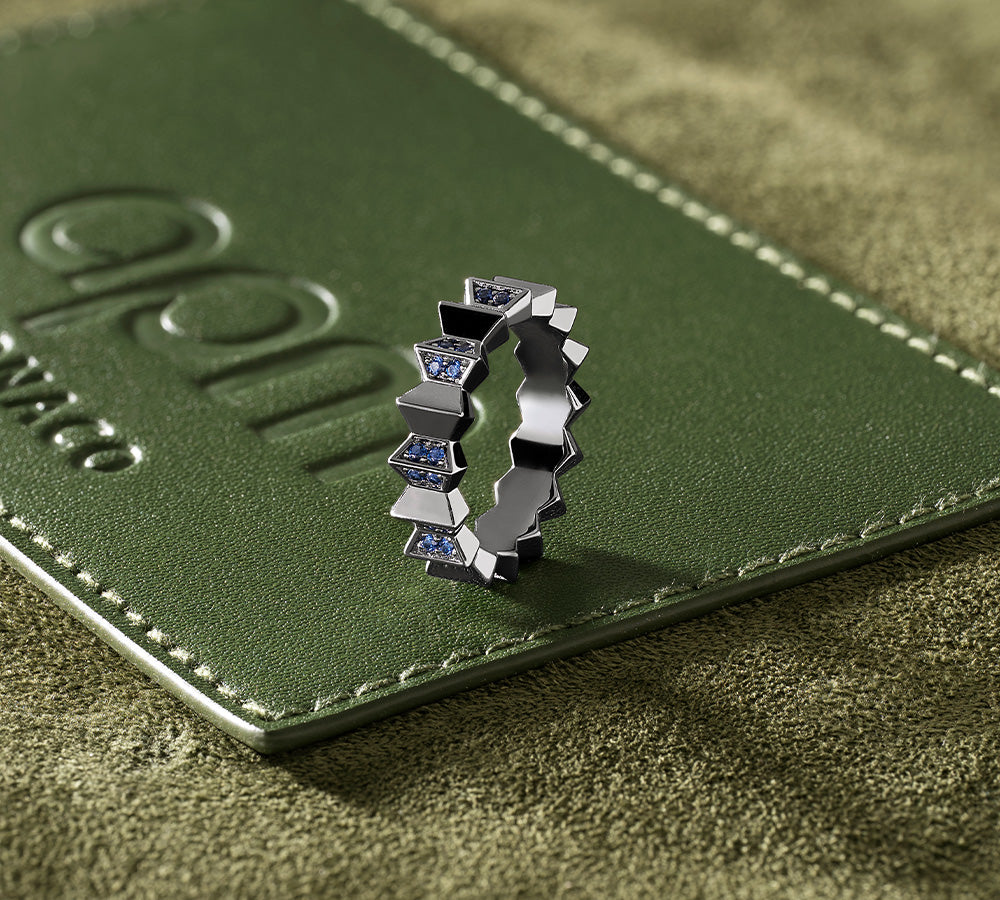 APM MONACO up and down silver ring on a green leather surface