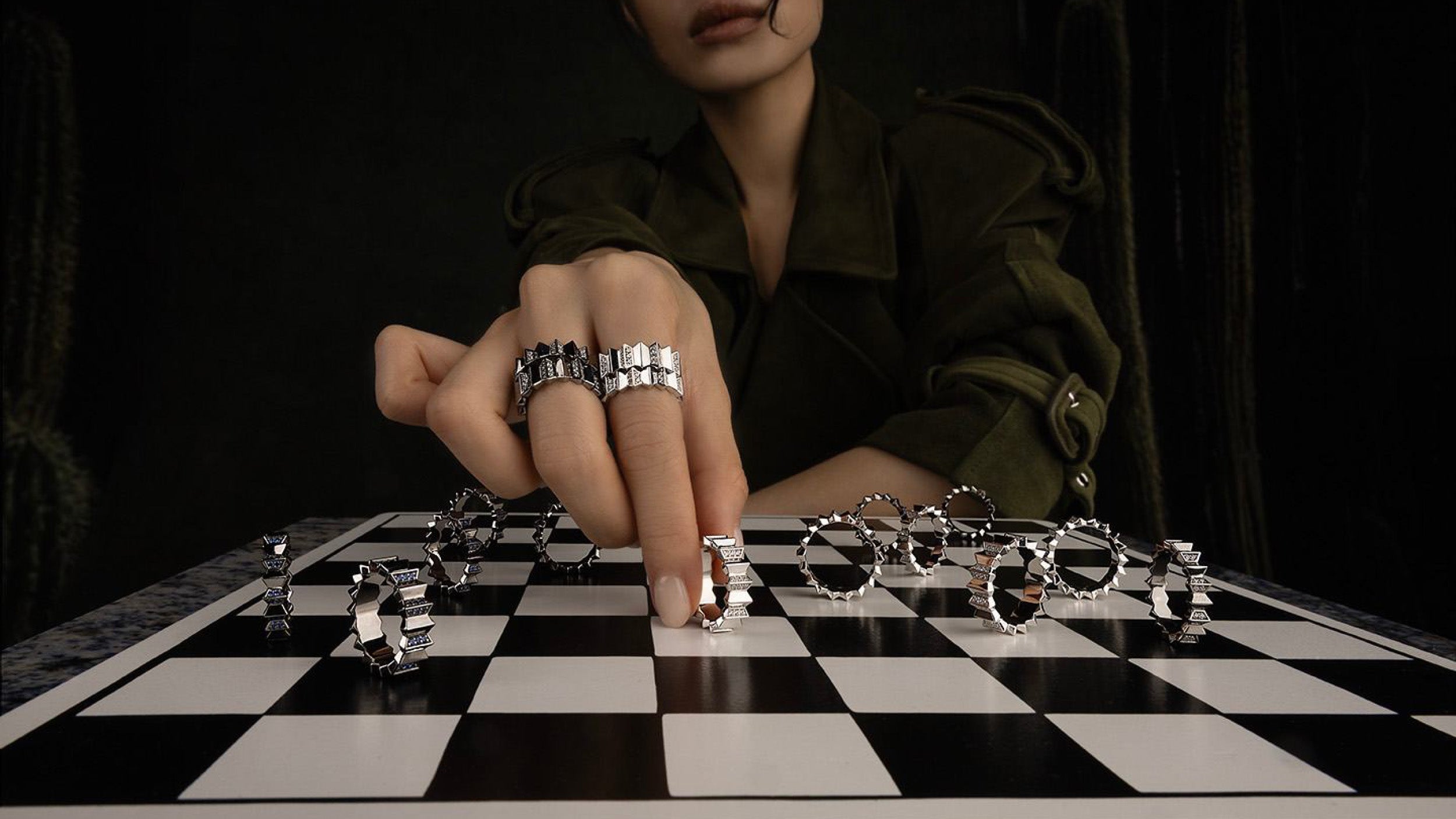 Person playing chess with metal automne up and down pieces on a checkered board