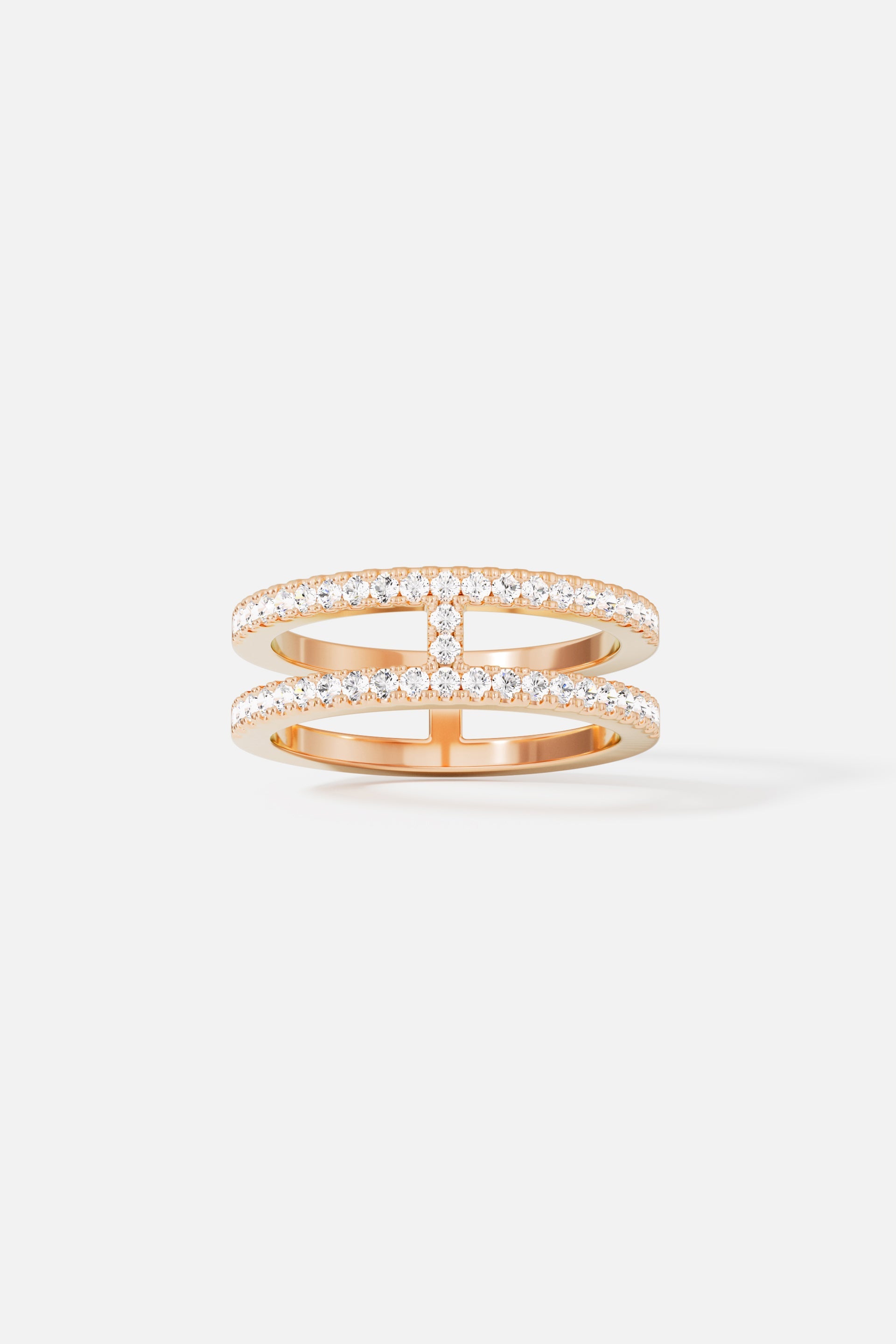 Rings APM Monaco. Double-line pavé ring featuring two parallel bands connected in the middle with pavé crystals, creating a sparkling, contemporary silhouette.