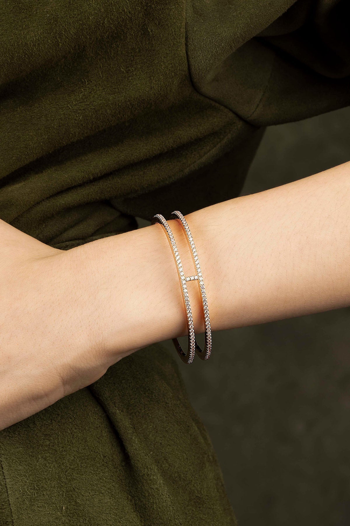 Close-up of a wrist wearing two bracelets with a blurred background