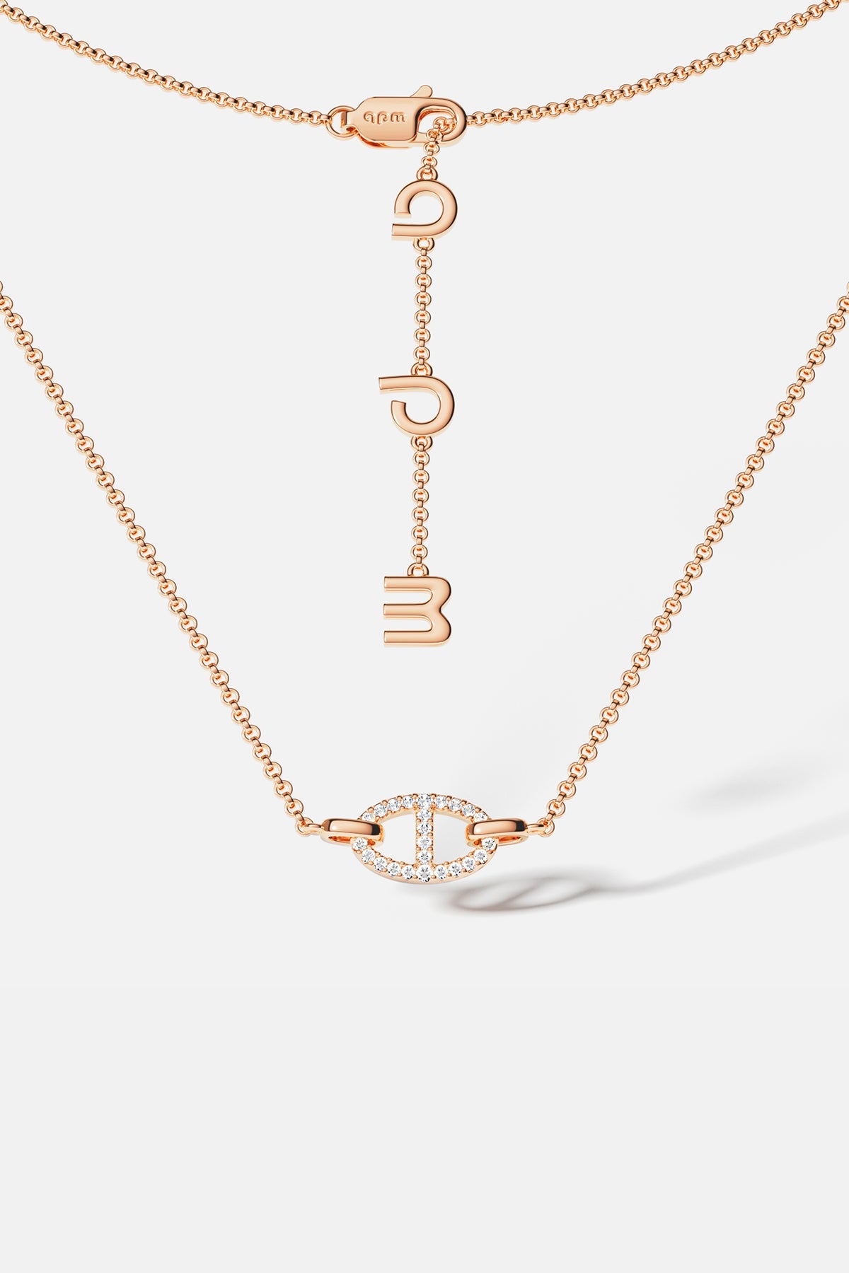 APM MONACO rose gold necklace with unique pendant on a white background