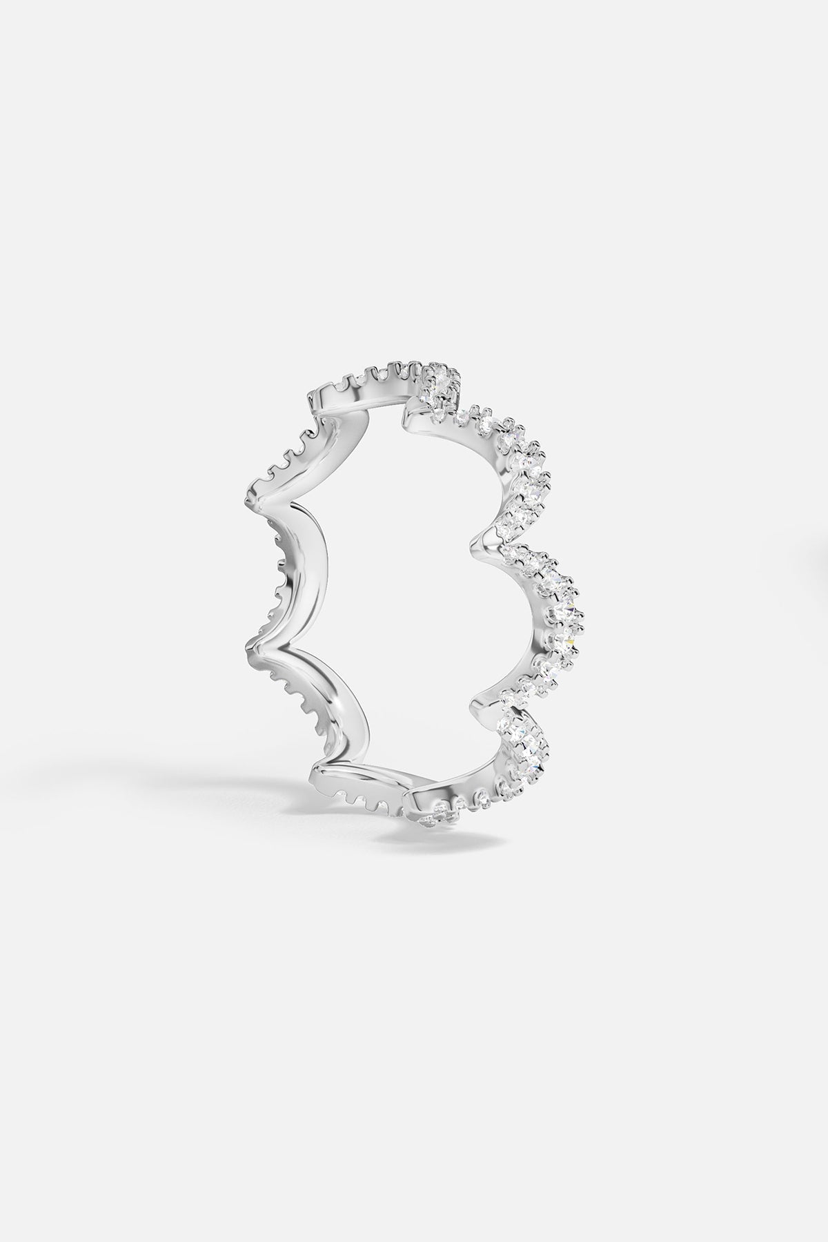 Silver tone ring with a wavy design on a white background