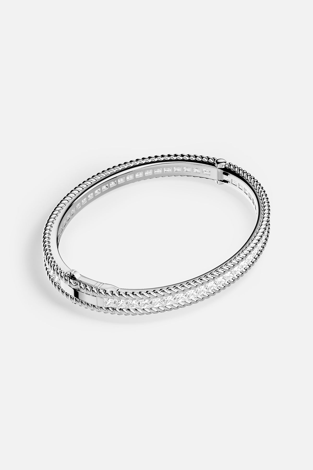 Silver bracelet with clear stones on a white background