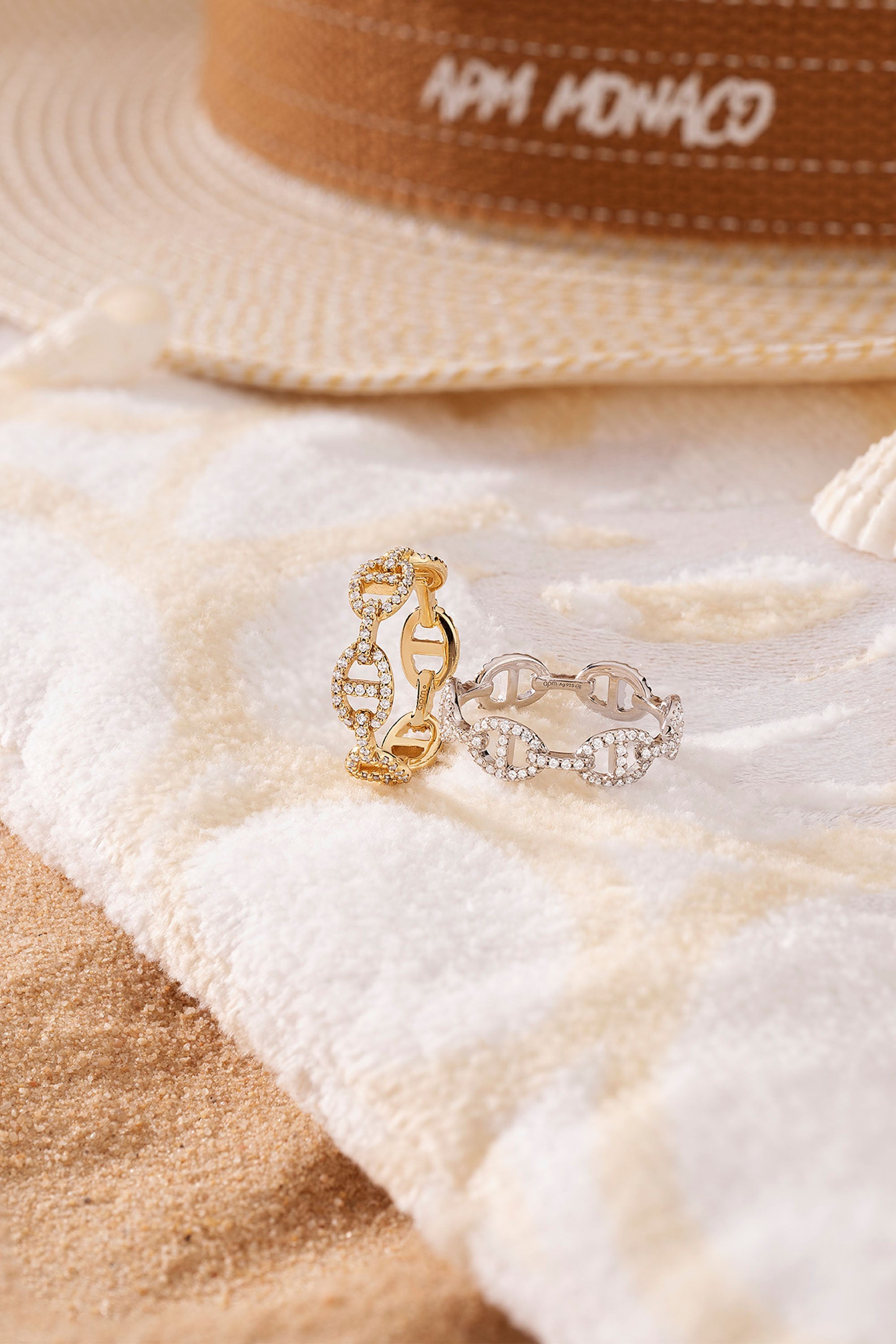 APM Monaco Maille Marine Ring in Yellow Gold worn on hand on soft blanket