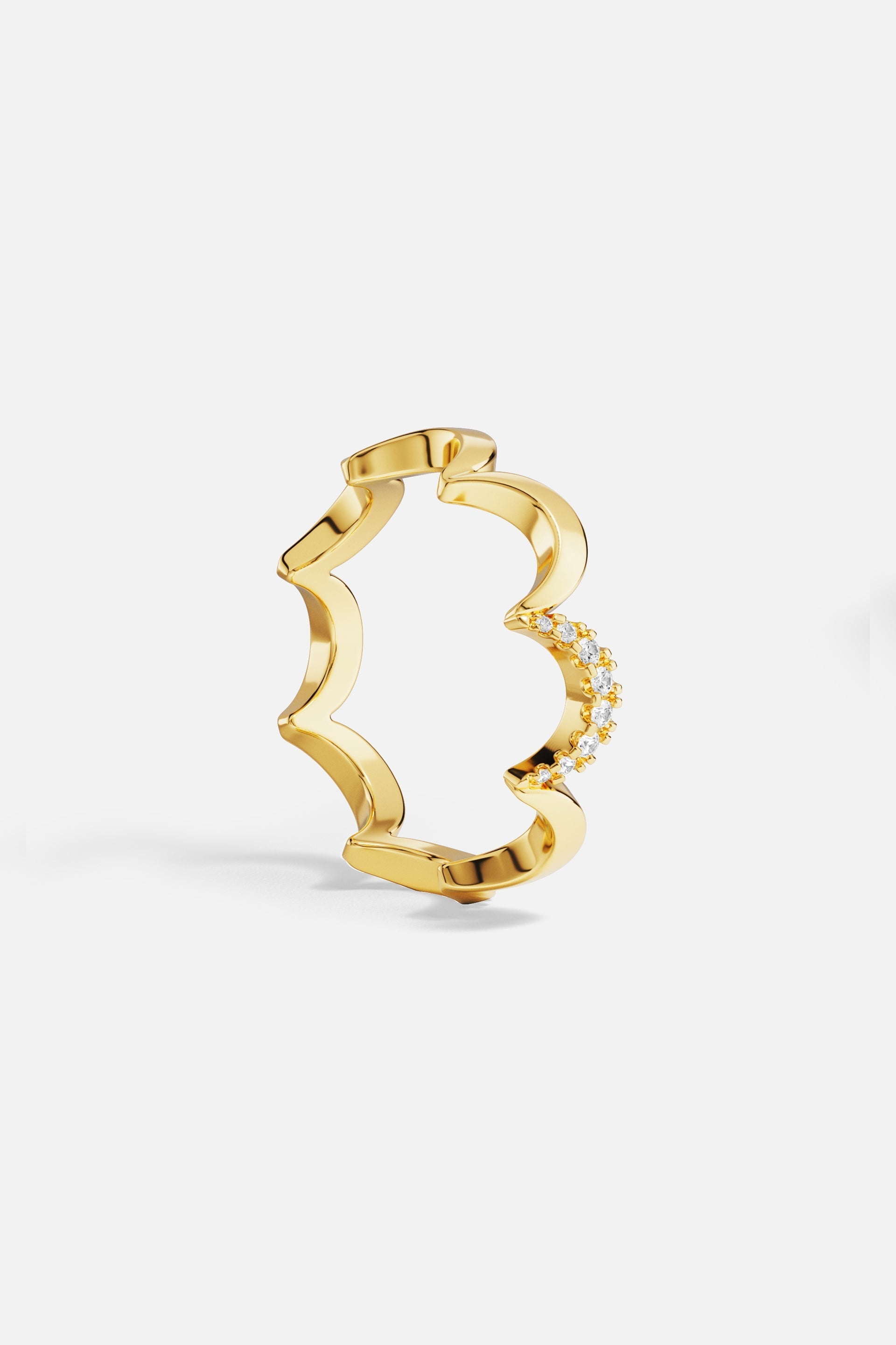 Rings APM Monaco yellow gold wavy pave ring with a row of diamonds along one side.
