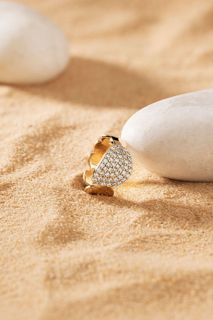 APM Monaco Galet Ring in Yellow Gold on soft beach